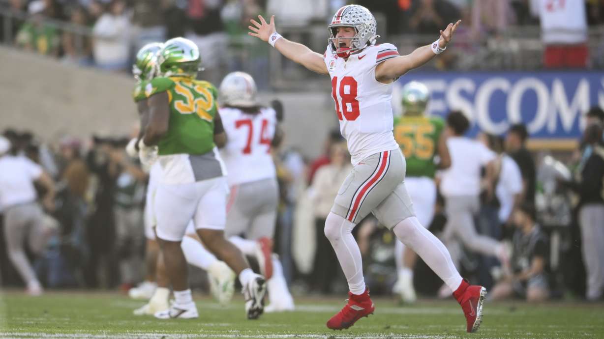 Ohio State quarterback Will Howard (18) celebrates a touchdown against Oregon during the first half in the quarterfinals of the Rose Bowl College Football Playoff, Wednesday, Jan. 1, 2025, in Pasadena, Calif.