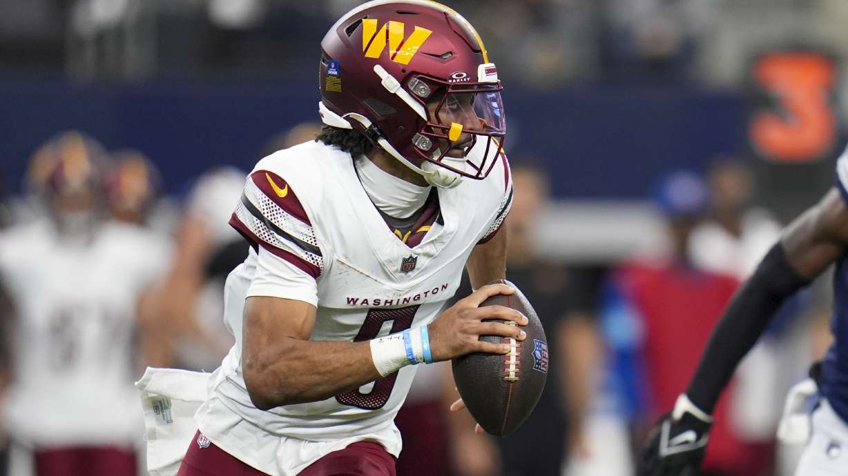 Washington Commanders quarterback Jayden Daniels looks to pass against the Dallas Cowboys during the first half of an NFL football game, Sunday, Jan. 5, 2025, in Arlington, Texas.