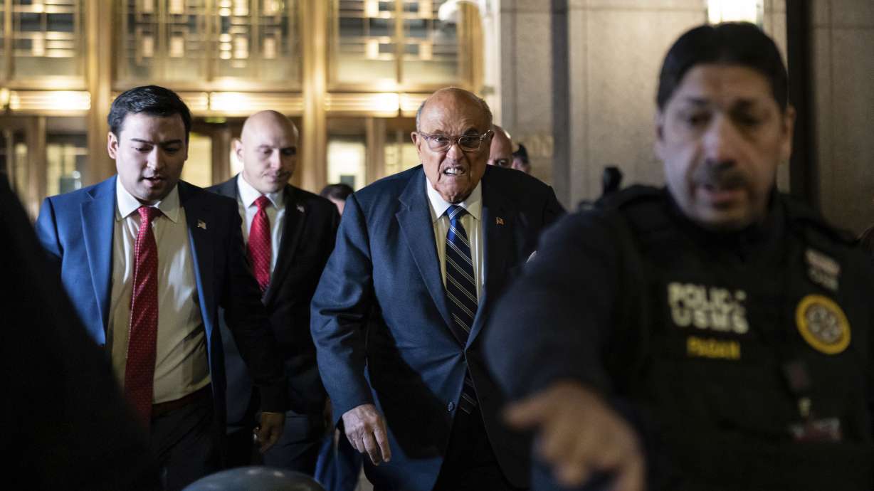Rudy Giuliani leaves Manhattan federal court in New York on Friday. A federal judge in New York City has found Giuliani in contempt of court.