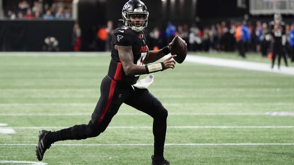 Atlanta Falcons quarterback Michael Penix Jr. runs for a touchdown against the Carolina Panthers during the first half of an NFL football game, Sunday, Jan. 5, 2025, in Atlanta.
