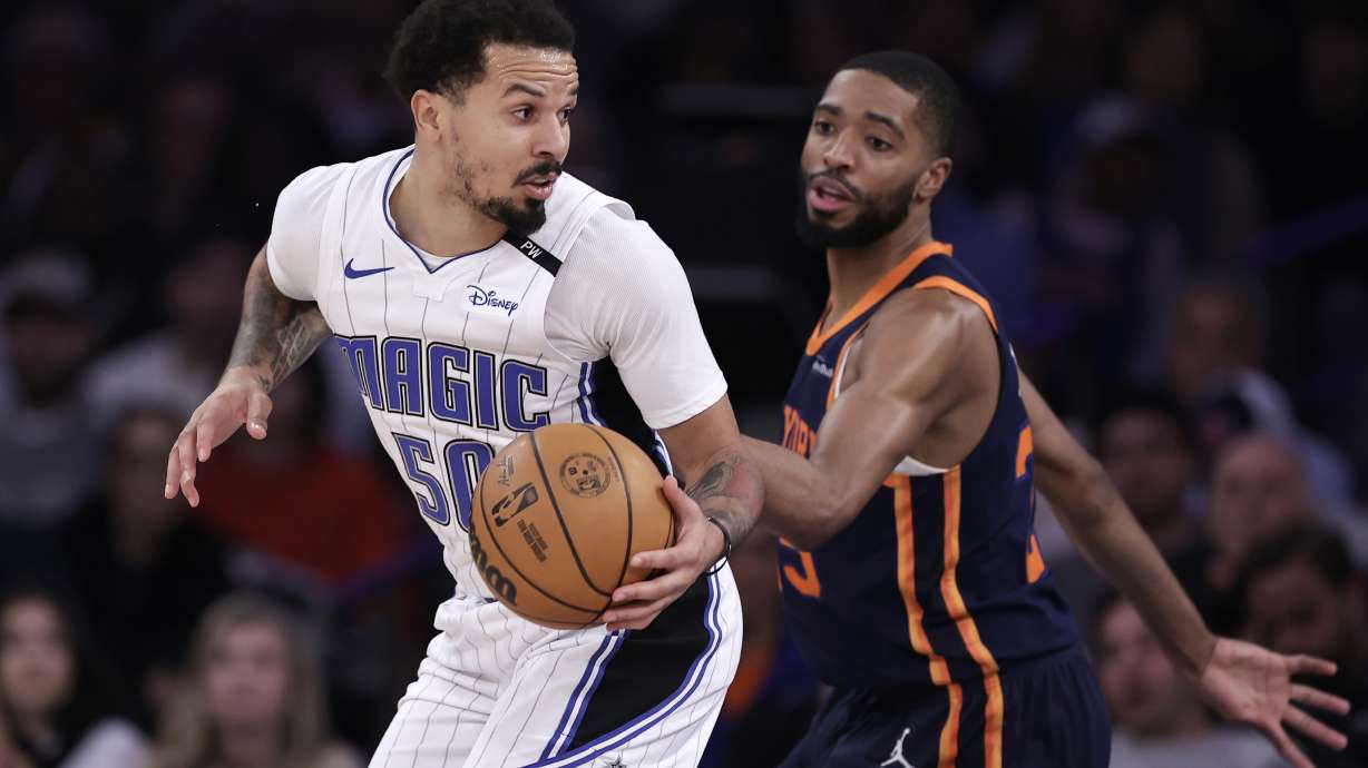 Orlando Magic guard Cole Anthony (50) drives against New York Knicks forward Mikal Bridges, right, during the first half of an NBA basketball game Monday, Jan. 6, 2025, in New York.