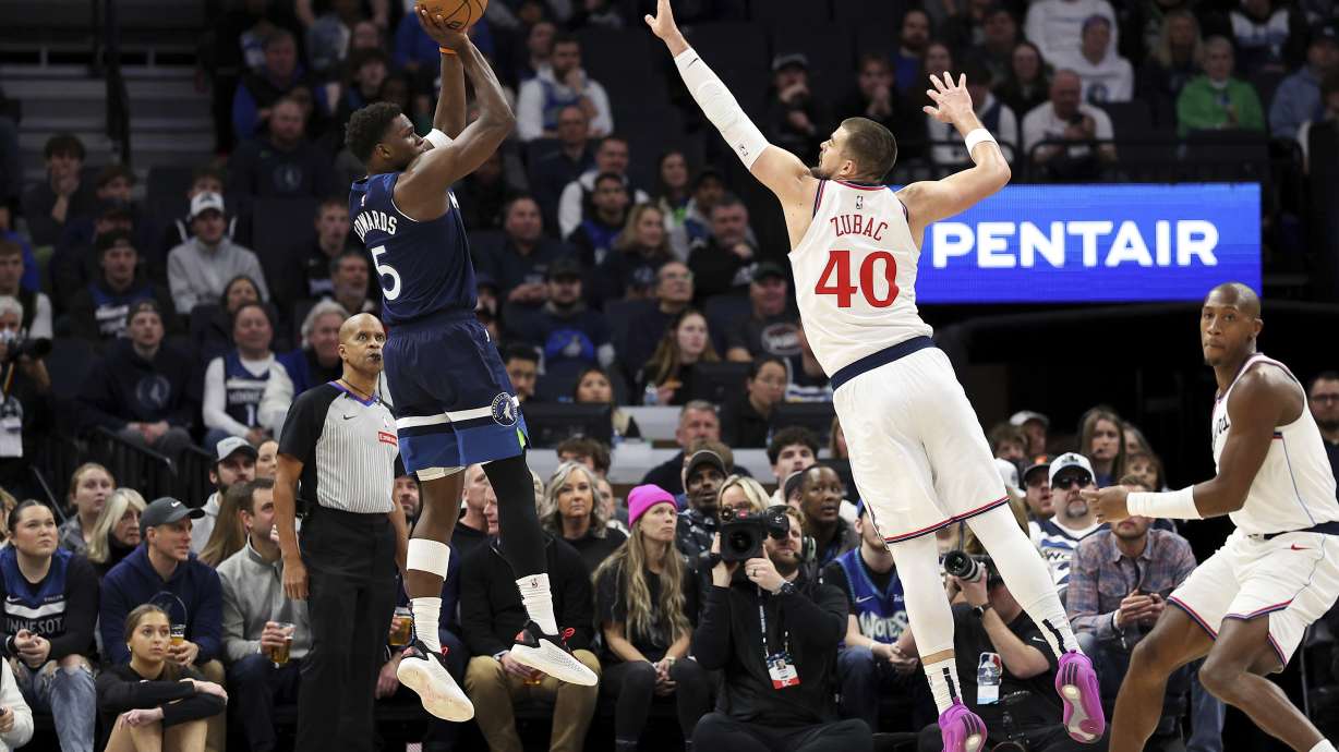 Minnesota Timberwolves guard Anthony Edwards, left, goes up to shoot as Los Angeles Clippers center Ivica Zubac (40) defends during the first half of an NBA basketball game Monday, Jan. 6, 2025, in Minneapolis.