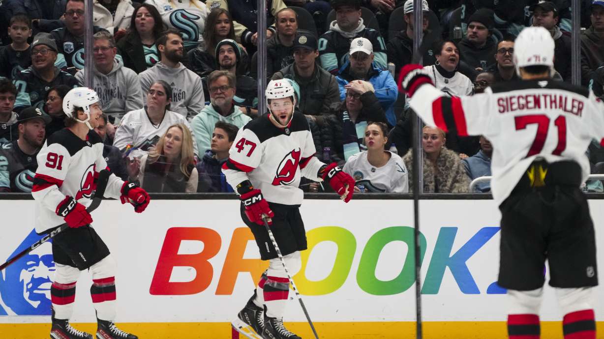 New Jersey Devils center Paul Cotter (47) celebrates his goal with center Dawson Mercer (91)ref10 and defenseman Jonas Siegenthaler (71) against the Seattle Kraken during the second period of an NHL hockey game Monday, Jan. 6, 2025, in Seattle.
