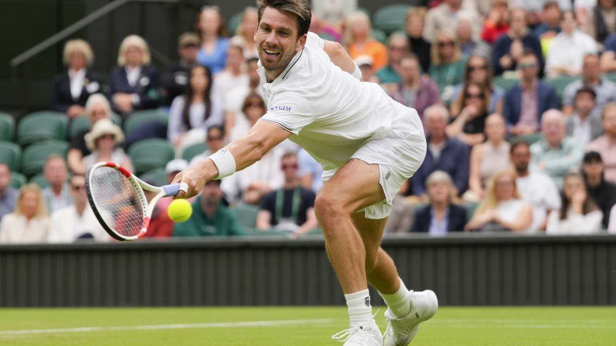FILE - Cameron Norrie, of Britain, plays a backhand return to Alexander Zverev, of Germany, during their third-round match at the Wimbledon tennis championships in London, July 6, 2024.