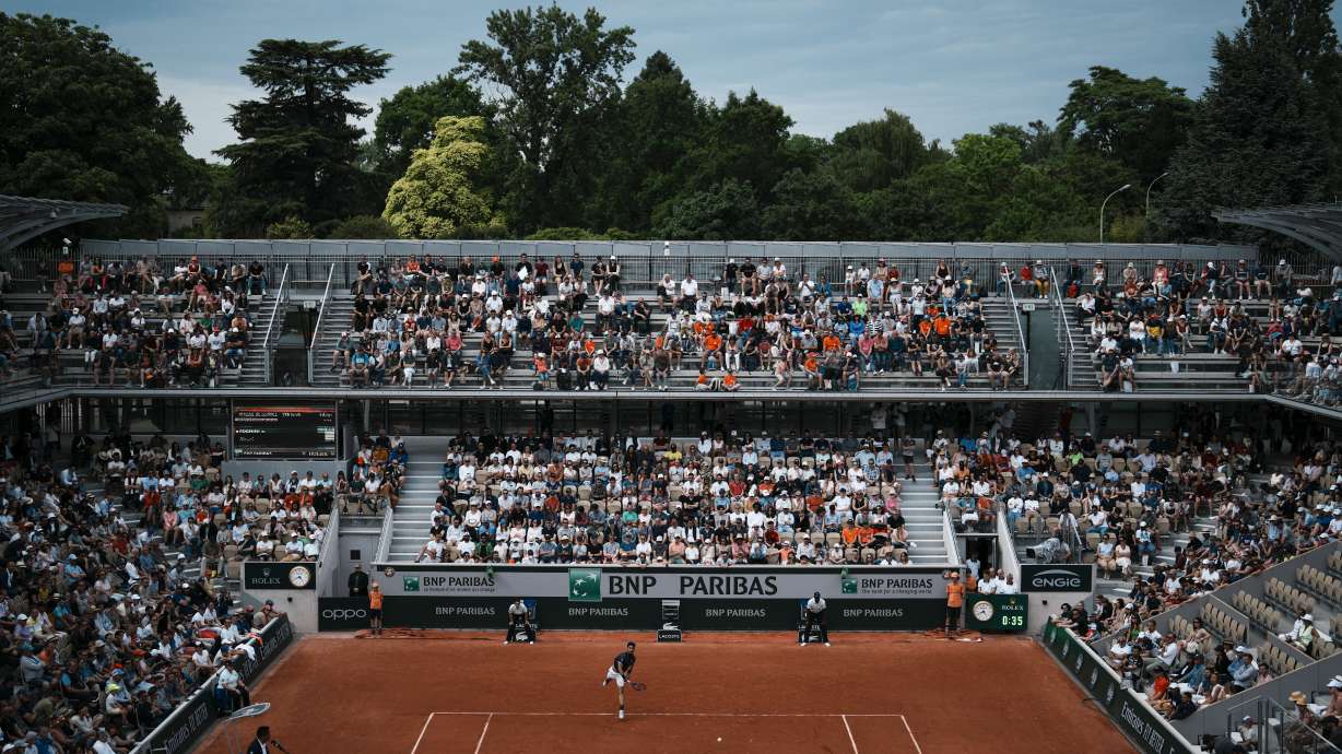 FILE -Spectators watch as Italy's Fabio Fognini serves against Australia's Alexei Popyrin during their first round match at the French Open tennis tournament in Roland Garros stadium in Paris, France, May 22, 2022.