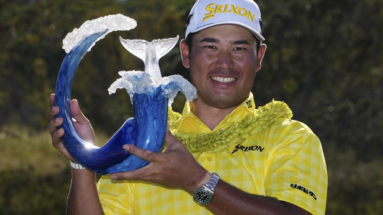 Hideki Matsuyama, of Japan, holds the champions trophy after the final round of The Sentry golf event, Sunday, Jan. 5, 2025, at Kapalua Plantation Course in Kapalua, Hawaii.