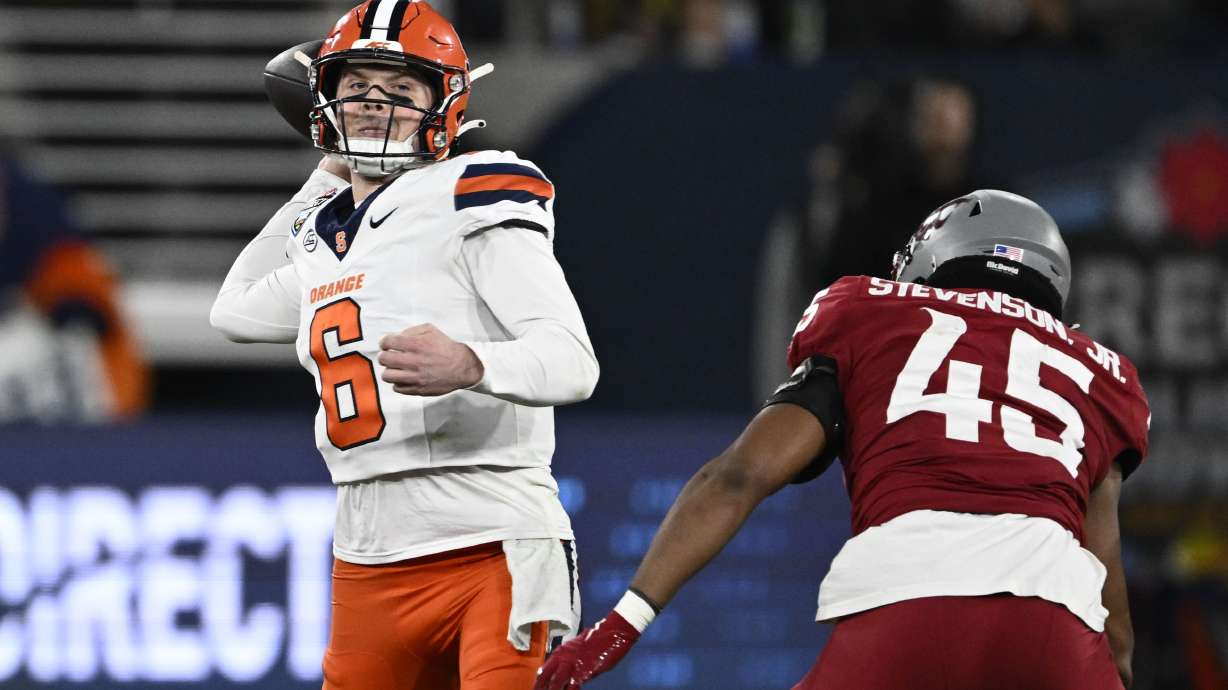 Syracuse quarterback Kyle McCord (6) passes under pressure from Washington State edge Raam Stevenson (45) during the first half of the Holiday Bowl NCAA college football game Friday, Dec. 27, 2024, in San Diego.