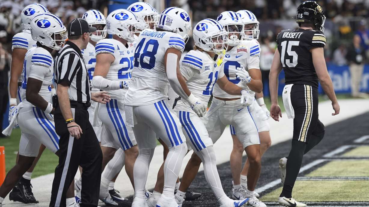 BYU wide receiver Parker Kingston (11) and teammates celebrate after he returned a punt by Colorado punter Mark Vassett (15) for a touchdown during the first half of the Alamo Bowl NCAA college football game, Saturday, Dec. 28, 2024, in San Antonio.