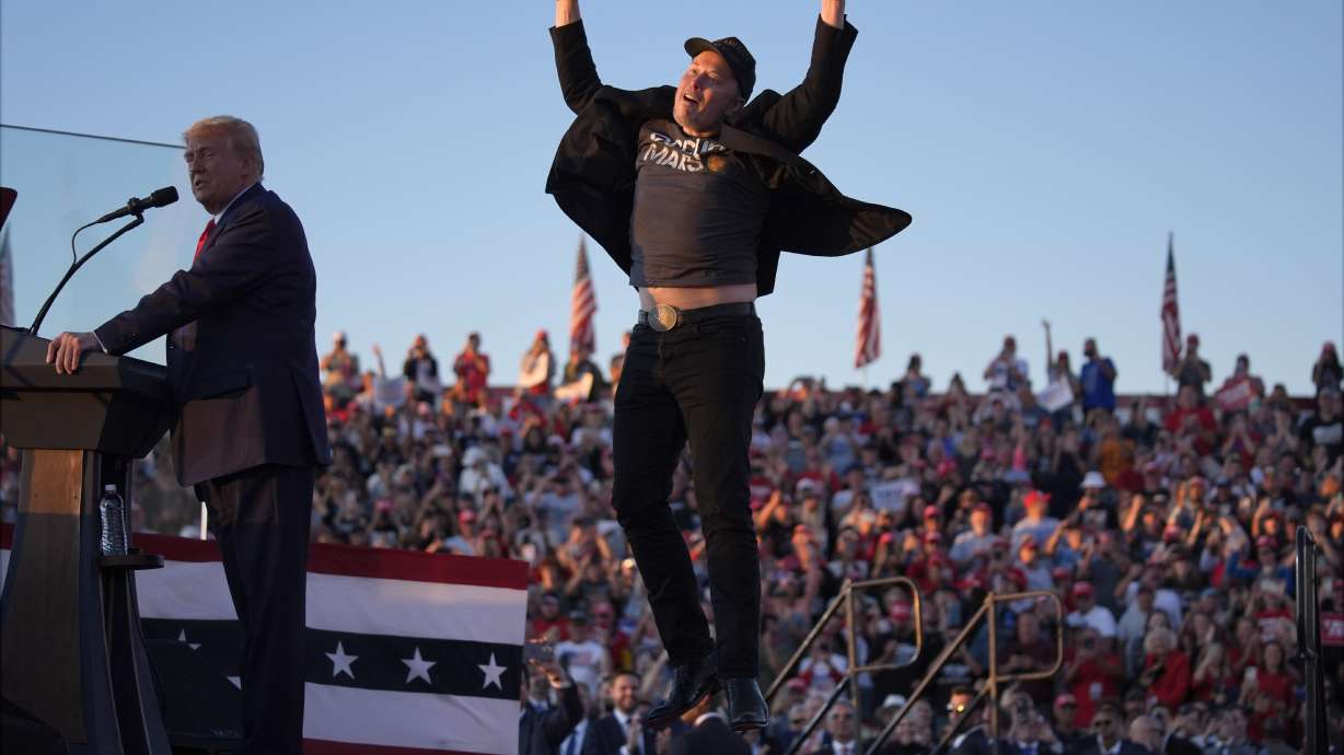 FILE - Elon Musk jumps on the stage as Republican presidential nominee former President Donald Trump speaks during a campaign rally at the Butler Farm Show on Oct. 5, 2024, in Butler, Pa.