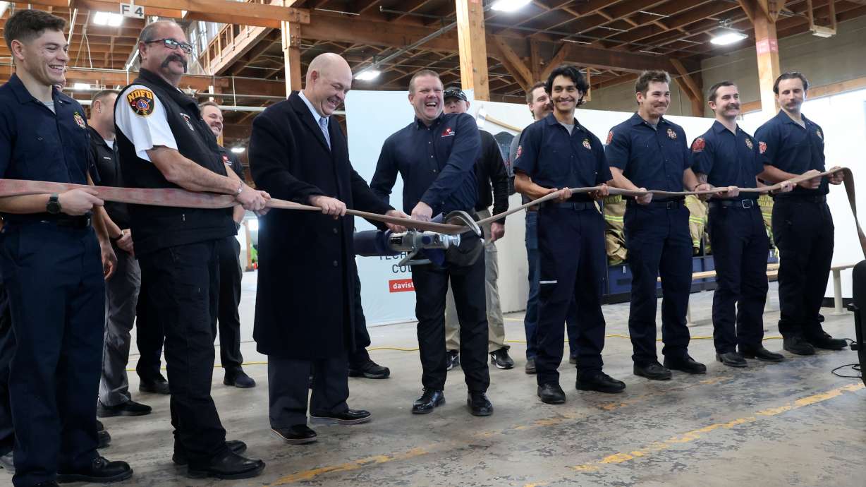 Jared Sholly, Davis Technical College Emergency Services training officer, uses Jaws of Life to cut a fire hose at a ribbon-cutting ceremony for the new Emergency Services Training Lab at Davis Technical College in Clearfield on Tuesday.