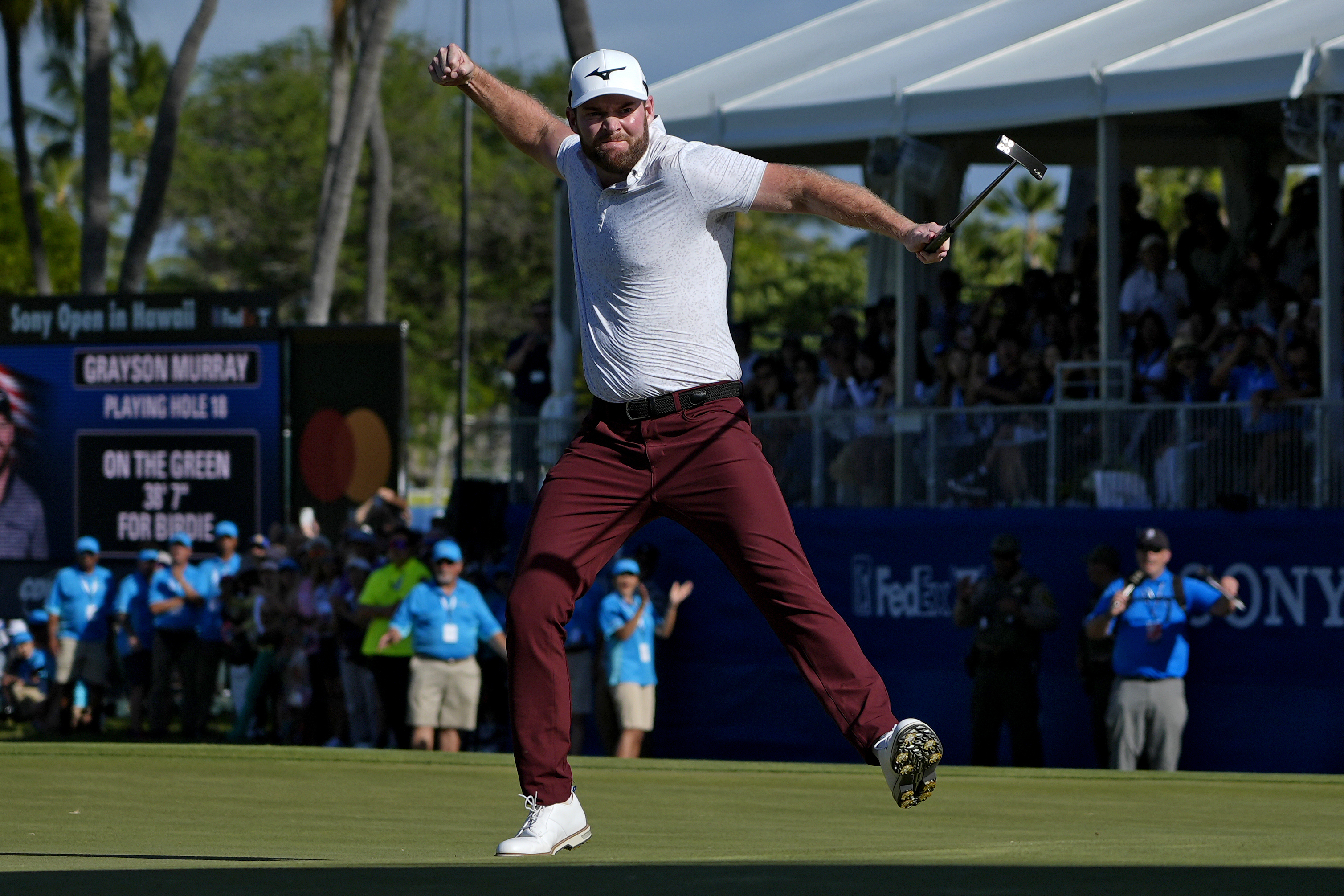 FILE - Grayson Murray celebrates winning the Sony Open golf event, Sunday, Jan. 14, 2024, at Waialae Country Club in Honolulu.