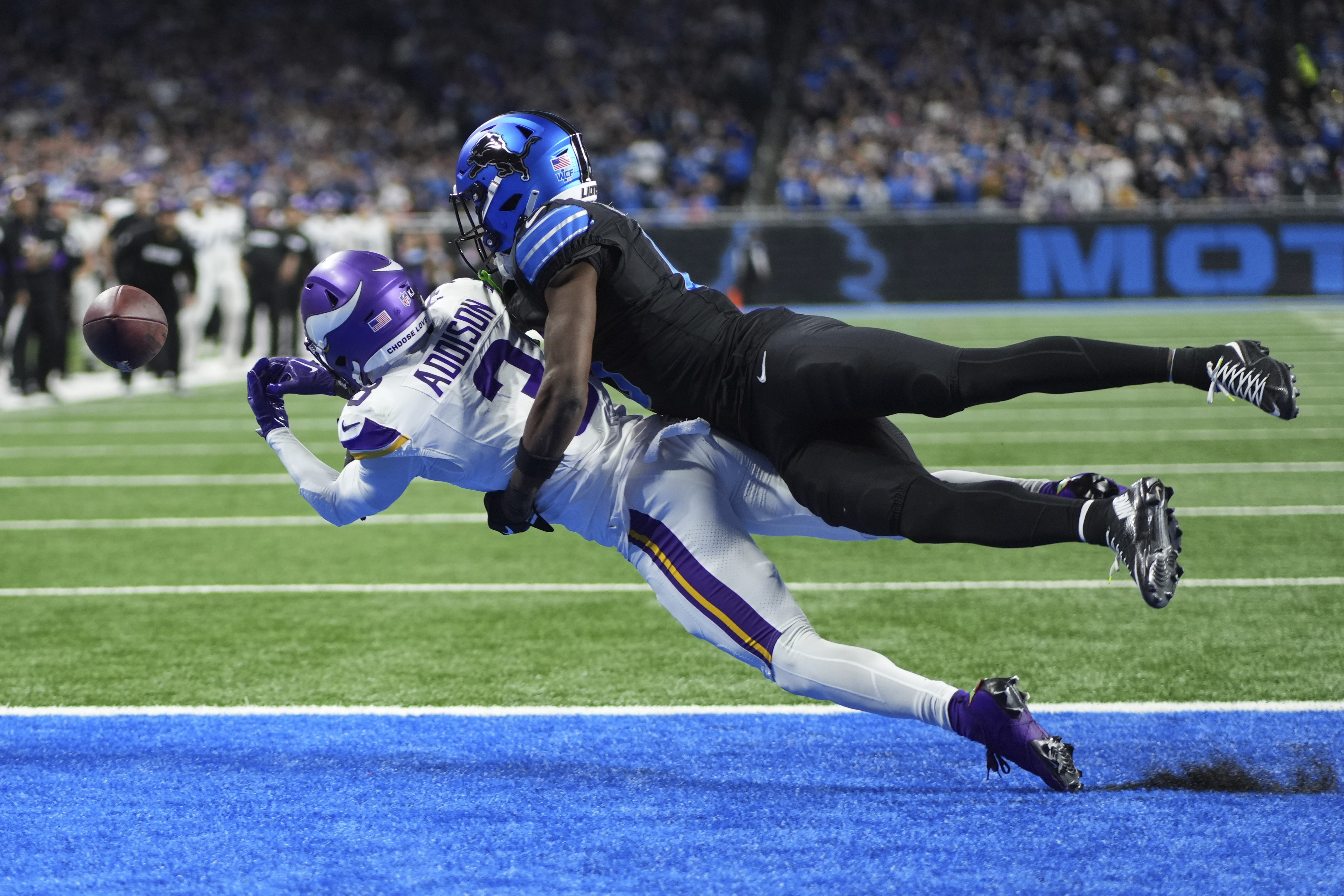 Detroit Lions cornerback Terrion Arnold, right, breaks up a pass intended for Minnesota Vikings wide receiver Jordan Addison, left, during the second half of an NFL football game Sunday, Jan. 5, 2025, in Detroit.