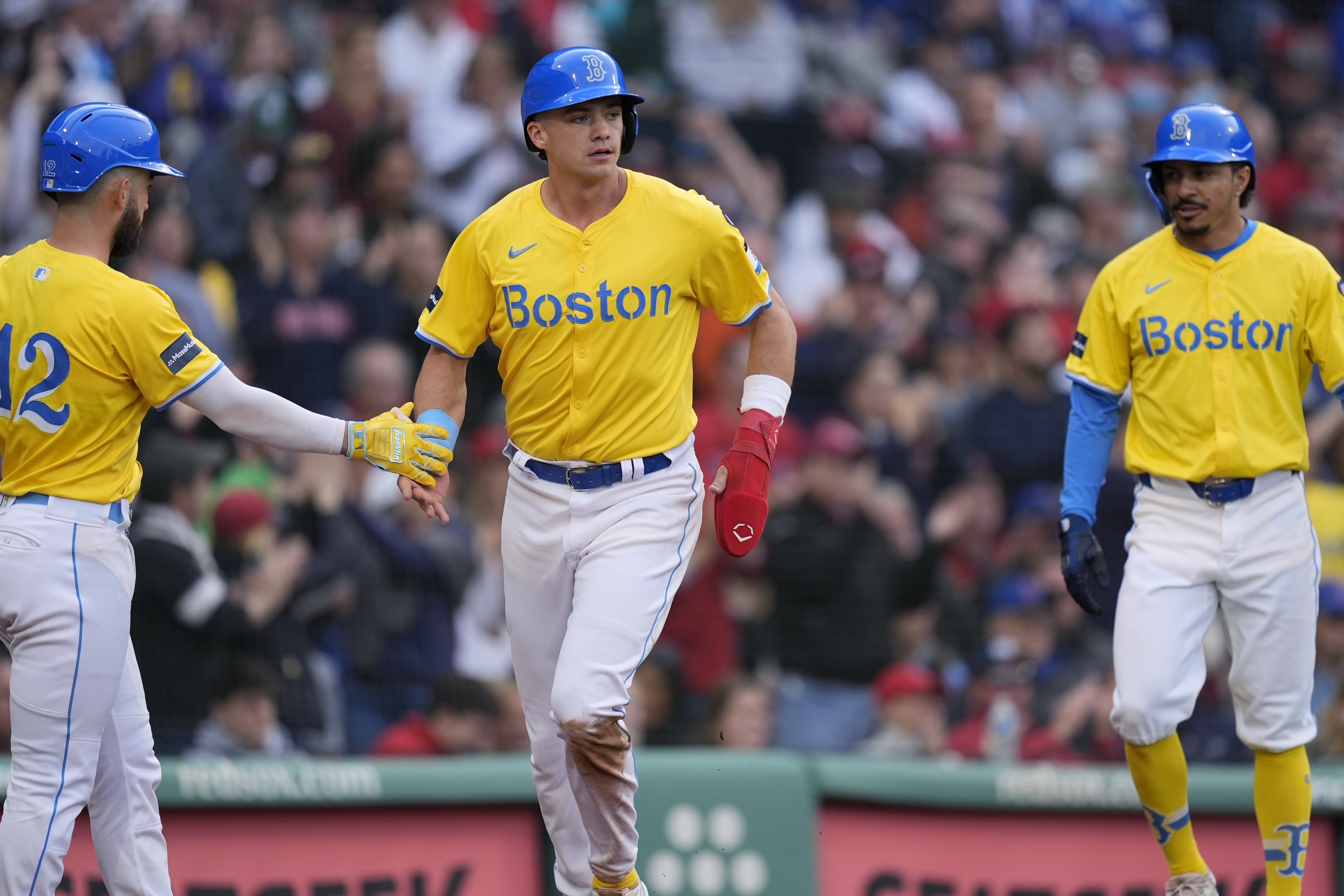 FILE - Boston Red Sox's Bobby Dalbec, center, celebrates after scoring on a three-run double by Ceddanne Rafaela that also drove in Connor Wong (12) and David Hamilton, right, during the fifth inning of a baseball game against the Chicago Cubs, April 27, 2024, in Boston.