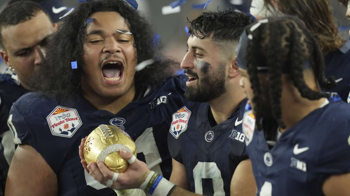 Penn State players celebrate after the Fiesta Bowl College Football Playoff game against Boise State, Tuesday, Dec. 31, 2024, in Glendale, Ariz.