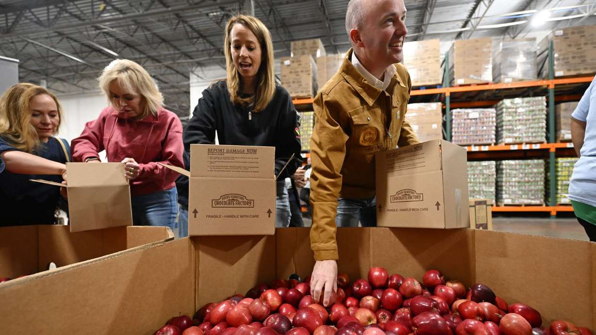 Gov. Spencer Cox and first lady Abby Cox and other government workers join together at the Utah Food Bank to serve in Salt Lake City on Tuesday.