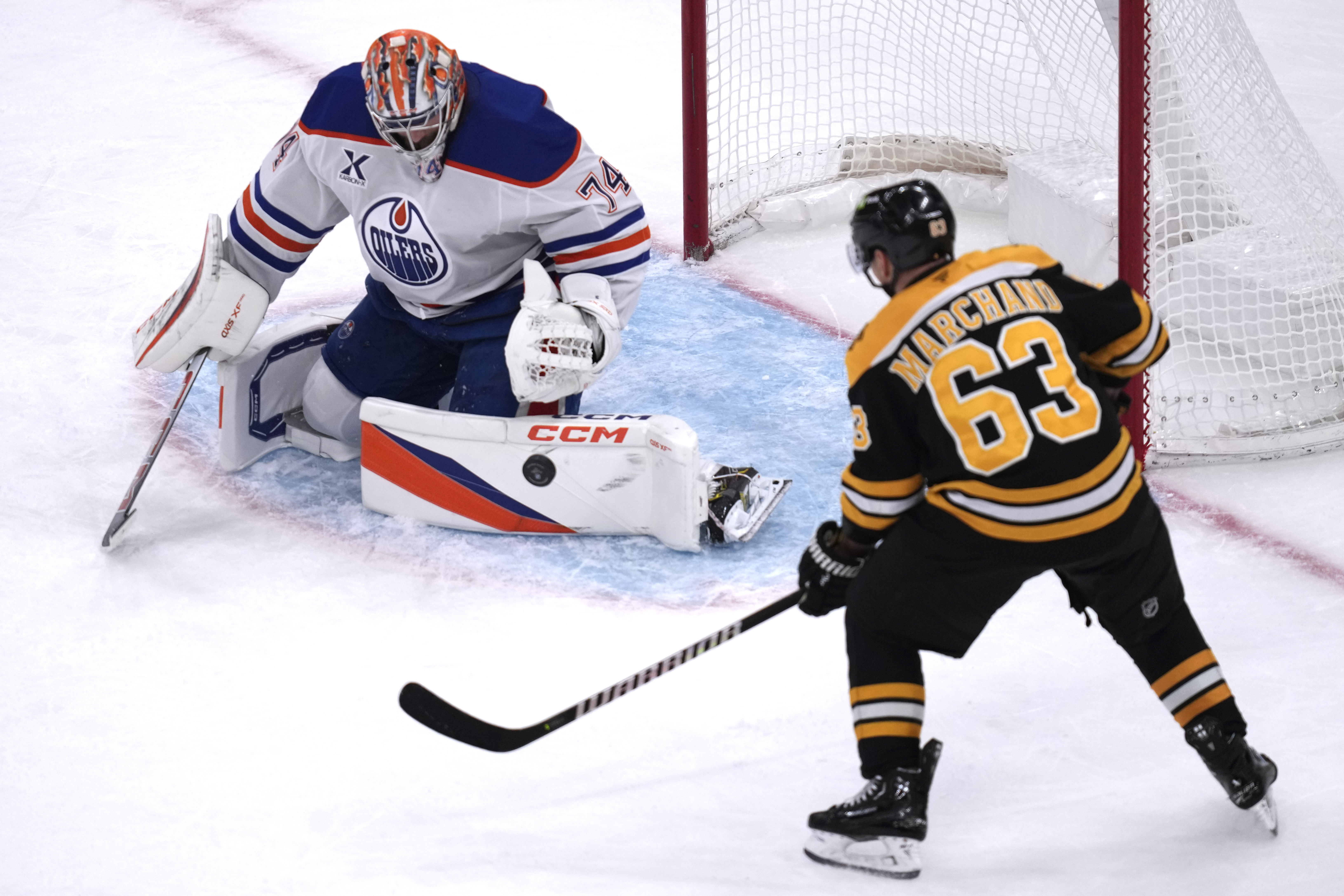Edmonton Oilers goaltender Stuart Skinner (74) makes a pad save on a shot by Boston Bruins left wing Brad Marchand (63) during the third period of an NHL hockey game, Tuesday, Jan. 7, 2025, in Boston.