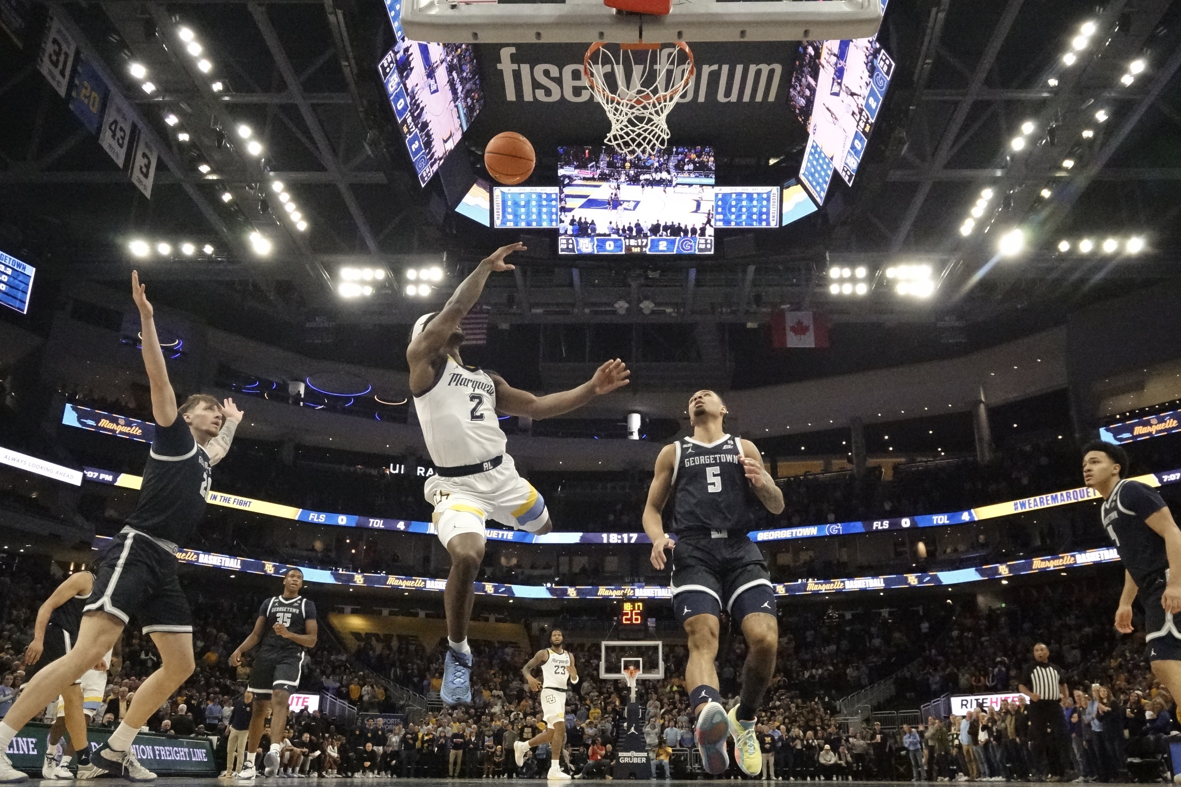 Marquette's Chase Ross shoots in front of Georgetown's Micah Peavy during the first half of an NCAA college basketball game Tuesday, Jan. 7, 2025, in Milwaukee. 