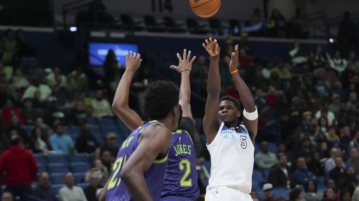 Minnesota Timberwolves guard Anthony Edwards (5) shoots against New Orleans Pelicans forward Herbert Jones (2) in the first half of an NBA basketball game in New Orleans, Tuesday, Jan. 7, 2025.