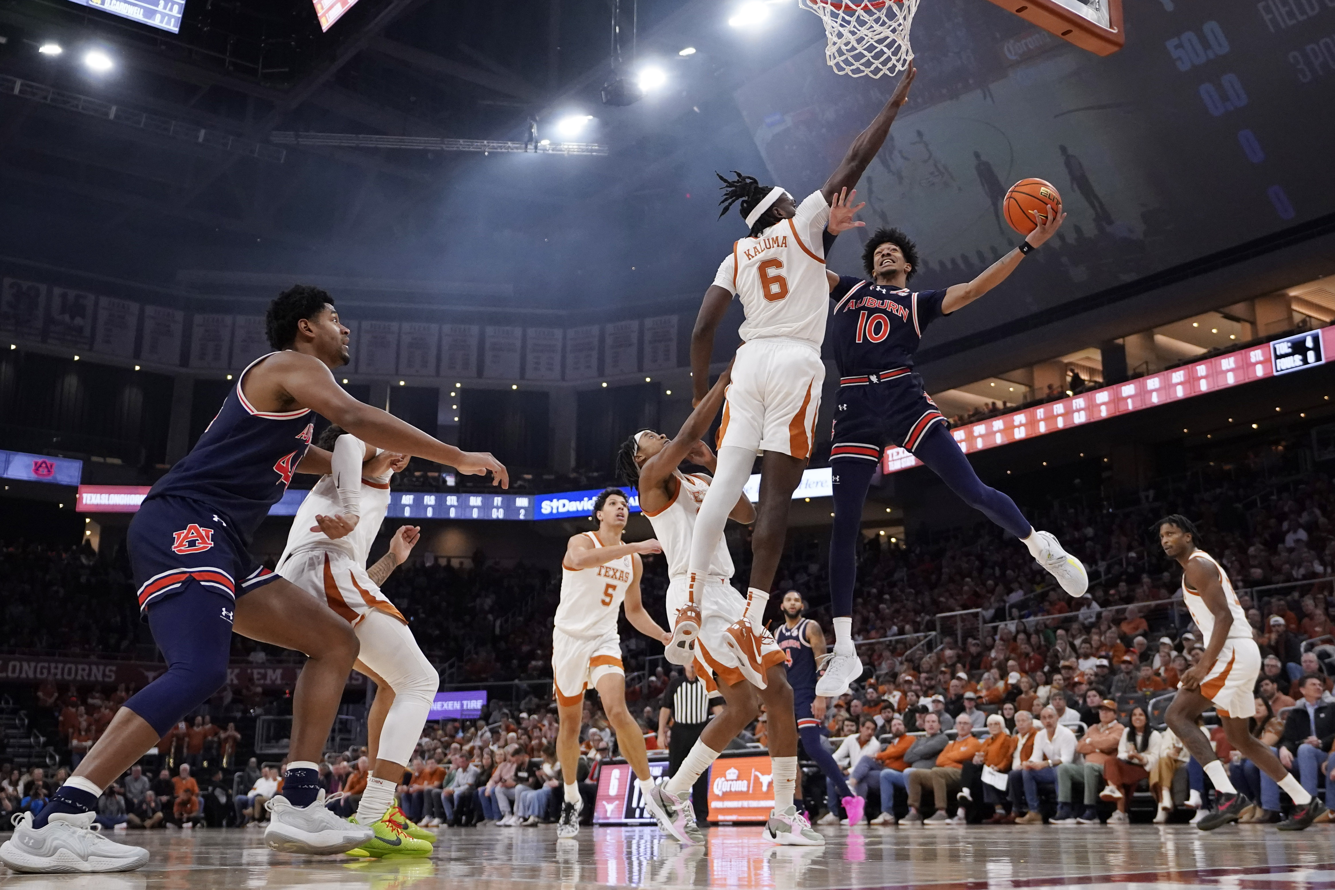 Auburn guard Chad Baker-Mazara (10) drives to the basket against Texas forward Arthur Kaluma (6) during the first half of an NCAA college basketball game in Austin, Texas, Tuesday, Jan. 7, 2025. 