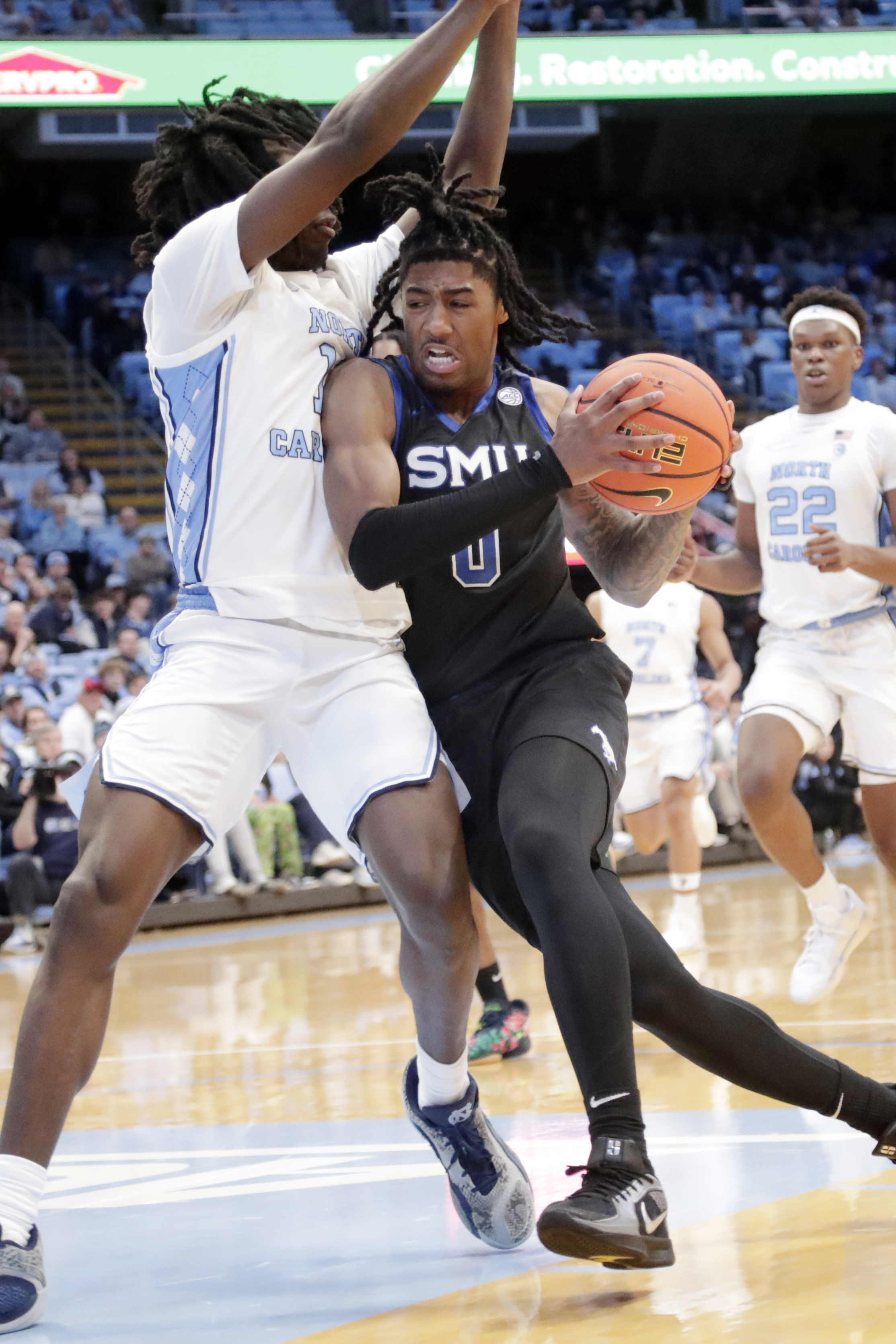 SMU guard B.J. Edwards (0) drives against North Carolina guard Ian Jackson, left, during the second half of an NCAA college basketball game Tuesday, Jan. 7, 2025, in Chapel Hill, N.C.