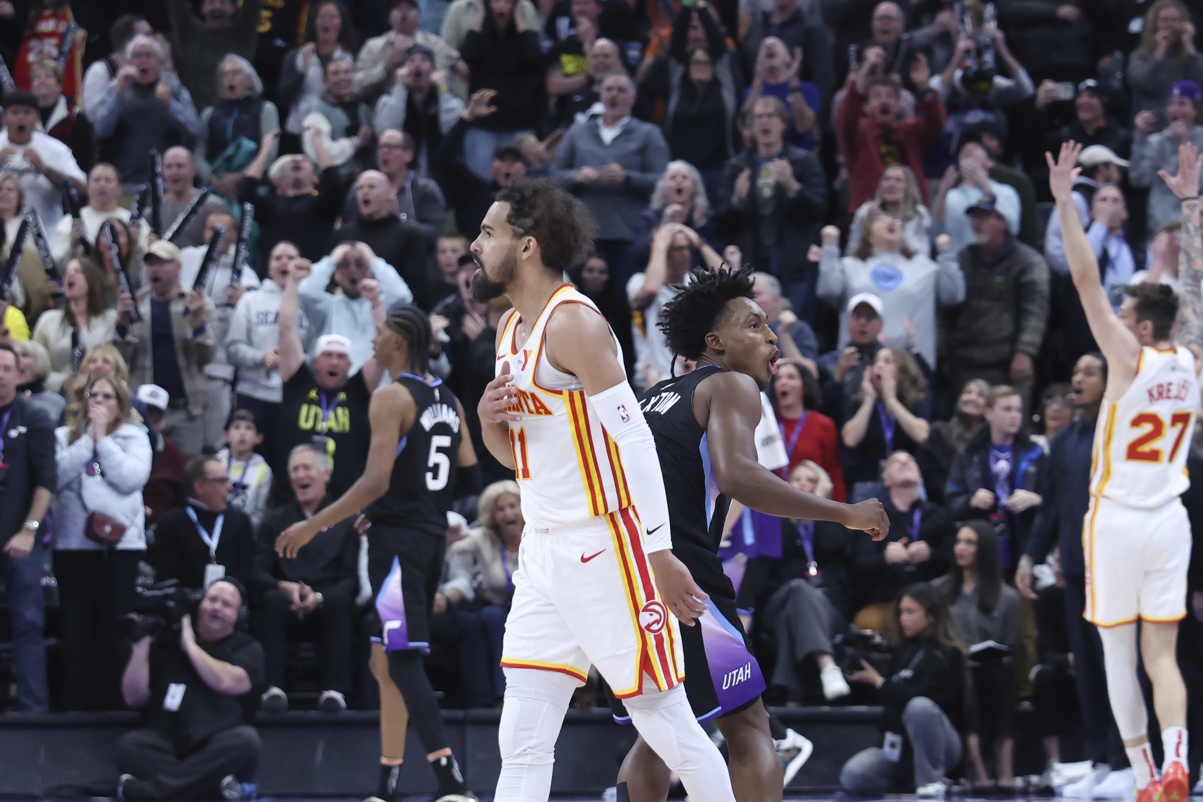 Atlanta Hawks guard Trae Young reacts to a game winning half court shot against the Utah Jazz during an NBA basketball game, Tuesday, Jan. 7, 2025, in Salt Lake City.