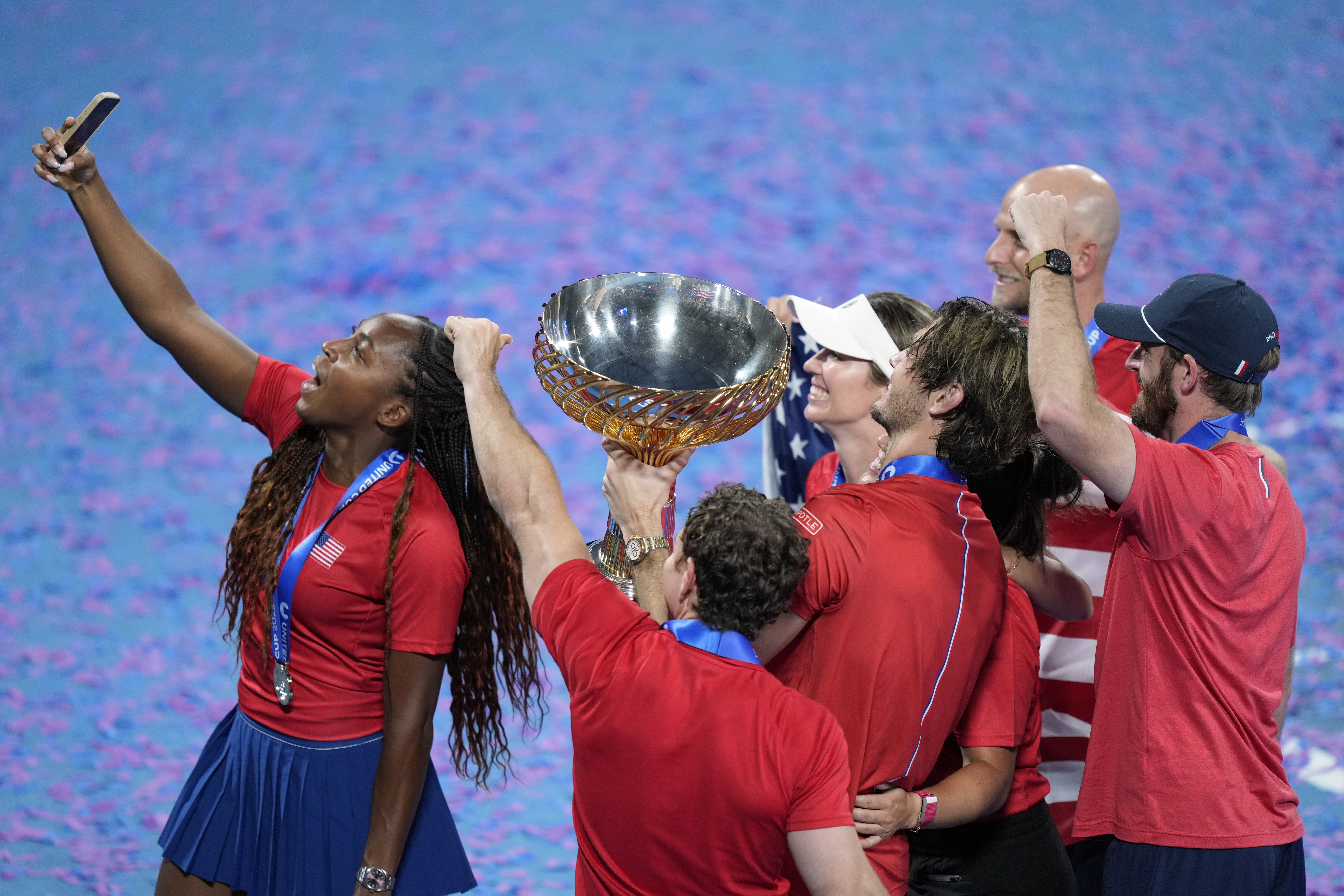 Coco Gauff of the U.S., left, takes a selfie with the rest of the team and their trophy after defeating Poland in the finals at the United Cup tennis tournament in Sydney, Australia, Sunday, Jan. 5, 2025.
