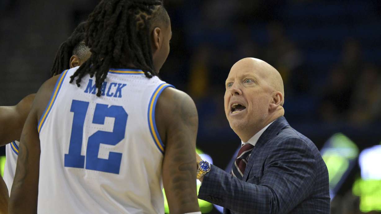 UCLA head coach Mick Cronin instructs UCLA guard Sebastian Mack (12) during the first half of an NCAA college basketball game against Michigan, Tuesday, Jan. 7, 2025, in Los Angeles.