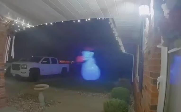 A snowman inflatable unexpectedly travels across a front yard in Bismarck, Illinois, in this Dec. 4, 2024, video.