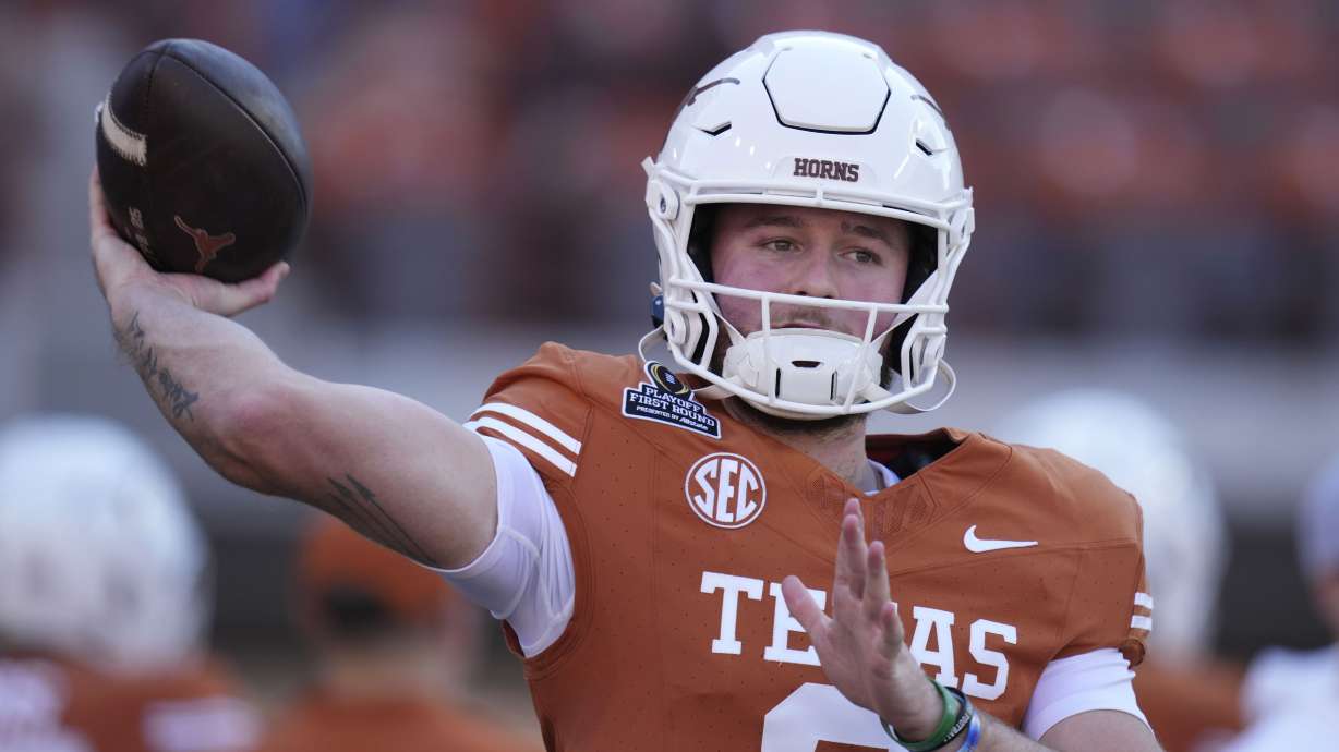Texas quarterback Quinn Ewers warms up before a first round game against Clemson in the College Football Playoff, Saturday, Dec. 21, 2024, in Austin, Texas.