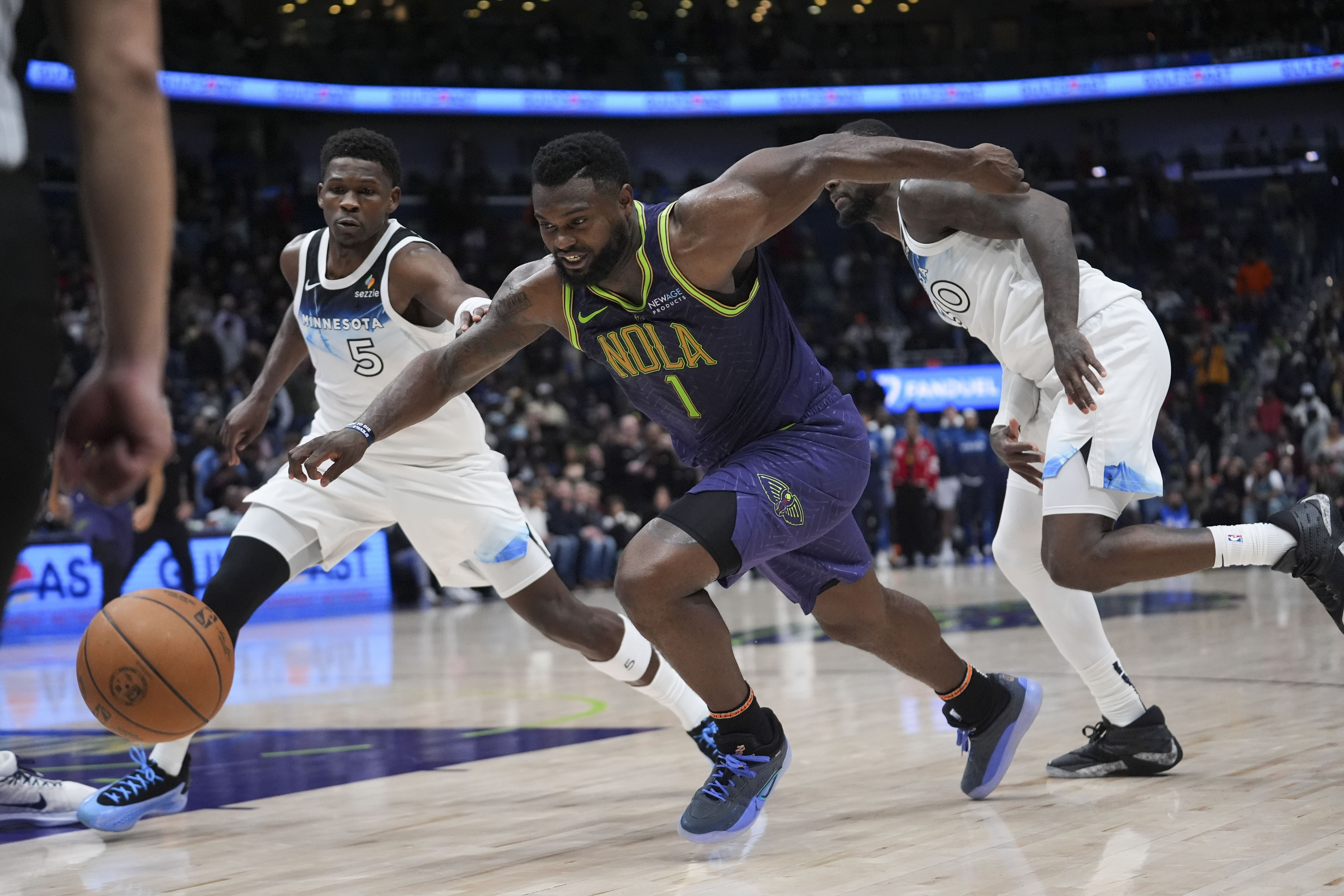 New Orleans Pelicans forward Zion Williamson (1) drives to the basket ahead of Minnesota Timberwolves guard Anthony Edwards (5) and forward Julius Randle (30) in the second half of an NBA basketball game in New Orleans, Tuesday, Jan. 7, 2025. The Timberwolves won 104-97 