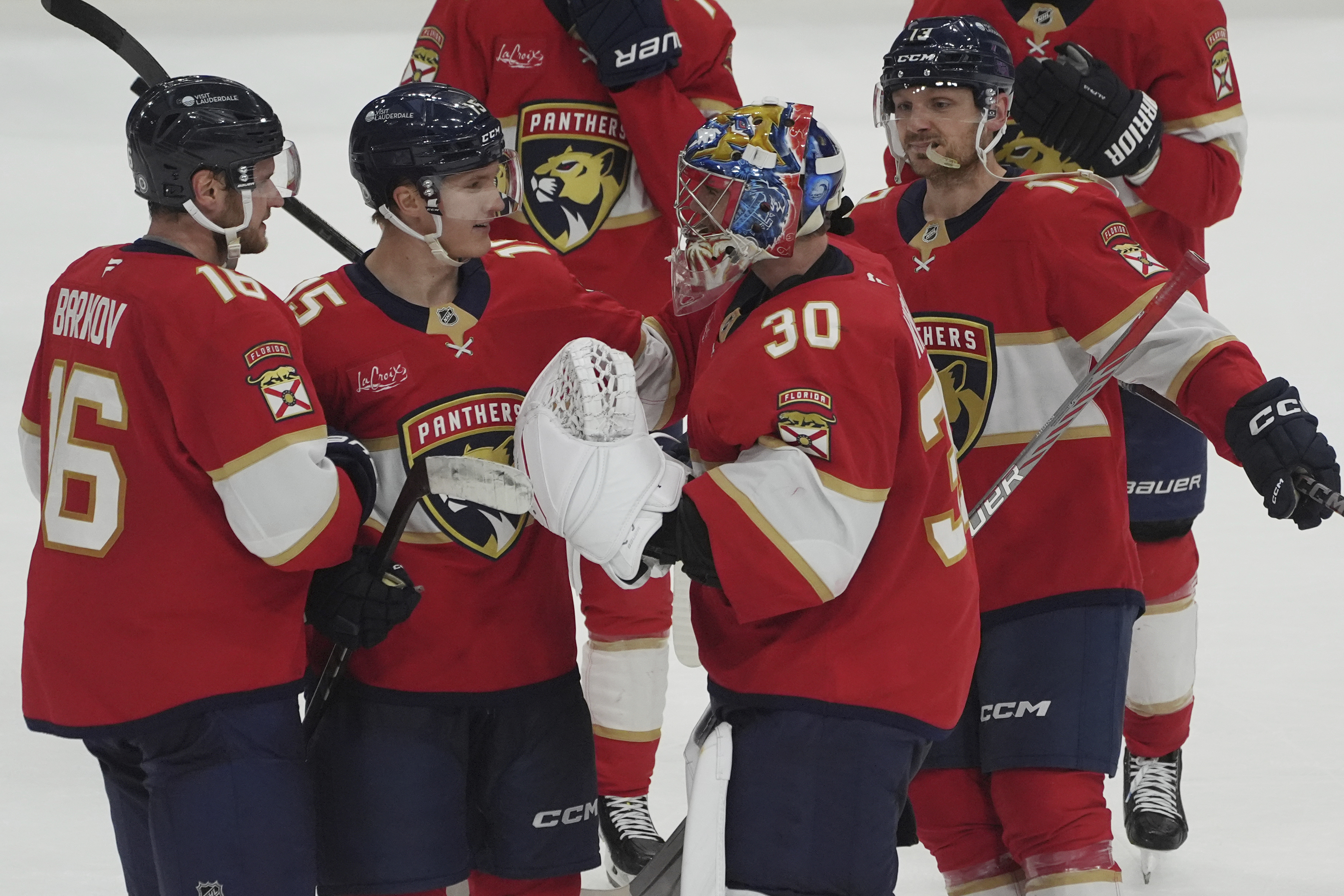 Florida Panthers goaltender Spencer Knight (30) celebrates with the team after defeating the Pittsburgh Penguins in a shootout at an NHL hockey game, Friday, Jan. 3, 2025, in Sunrise, Fla.