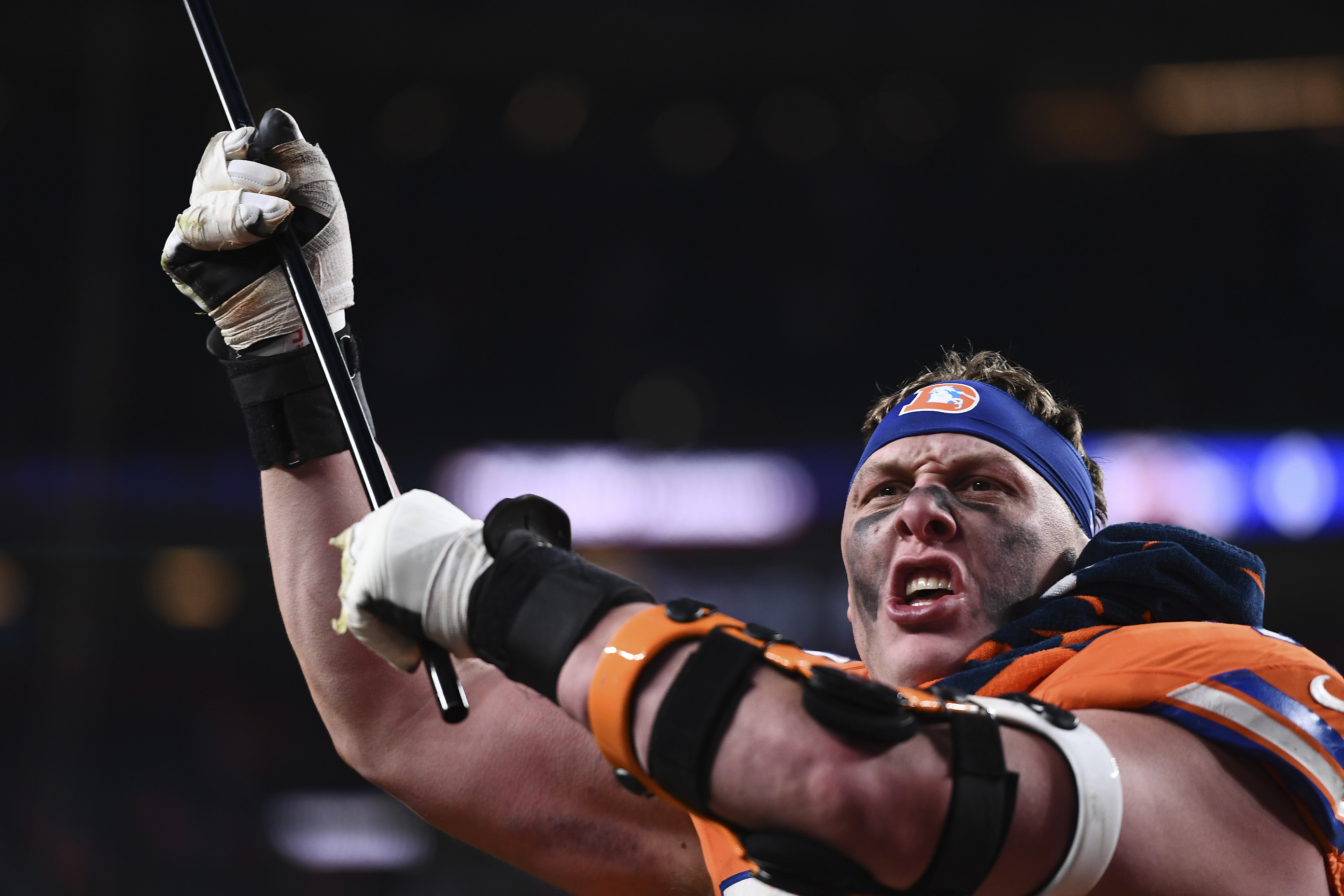 Denver Broncos offensive tackle Garett Bolles waves a flag after an NFL football game against the Kansas City Chiefs, Sunday, Jan. 5, 2025, in Denver.
