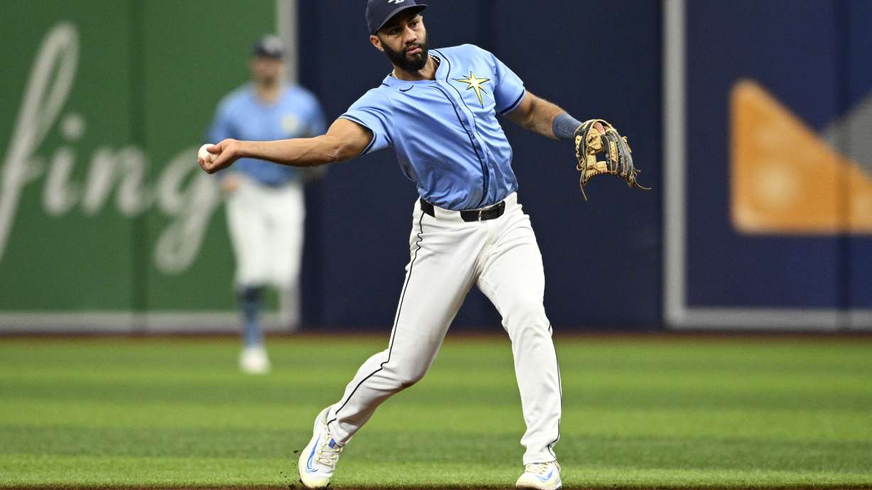 FILE -Tampa Bay Rays second baseman Amed Rosario throws to first base after fielding a ground ball during the first inning of a baseball game against the Cleveland Guardians, Sunday, July 14, 2024, in St. Petersburg, Fla. (AP Photo/Phelan M. Ebenhack, File0
