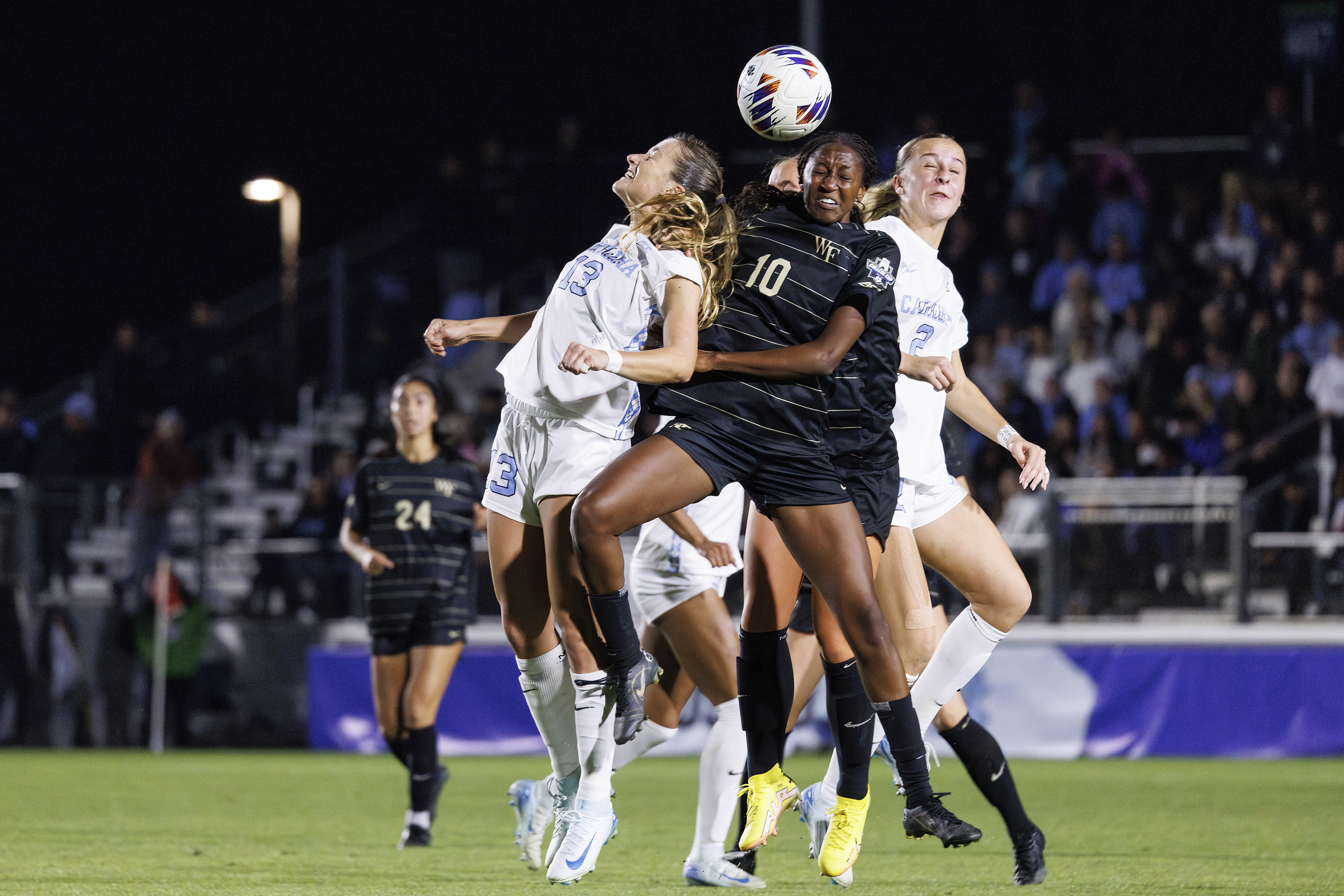 North Carolina's Kate Faasse and Wake Forest's Malaika Meena (10) battle for a ball during the second half of NCAA Women's College Cup soccer final in Cary, N.C., Monday, Dec. 9, 2024.