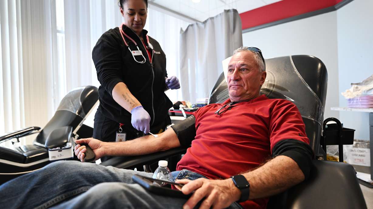Dennis Druce is assisted in his blood donation by technician Shea Proctor at the American Red Cross Murray location on Wednesday. Storms in the mid-Atlantic and Midwest have caused a blood shortage at a time when donations are usually low.