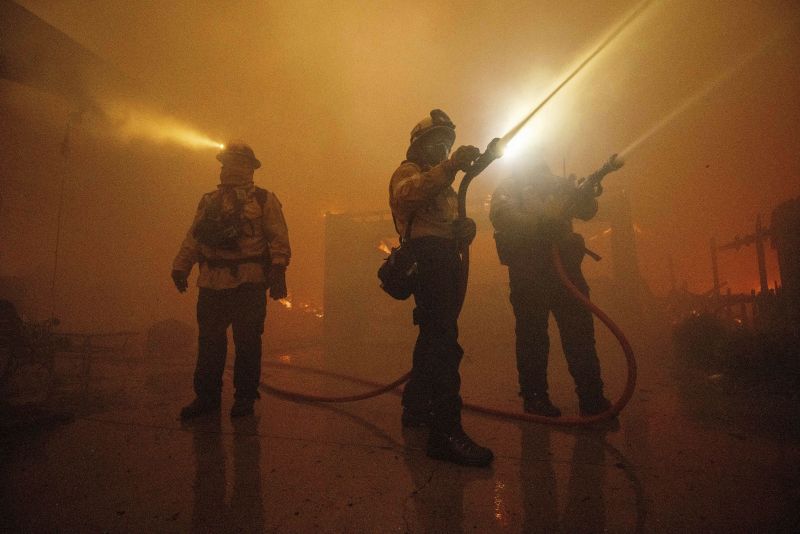 Fire crews battle the Eaton Fire Wednesday in Altadena, Calif.