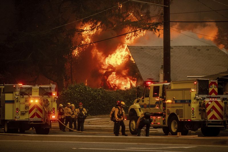 Firefighters battle the Eaton Fire Wednesday in Altadena, Calif.