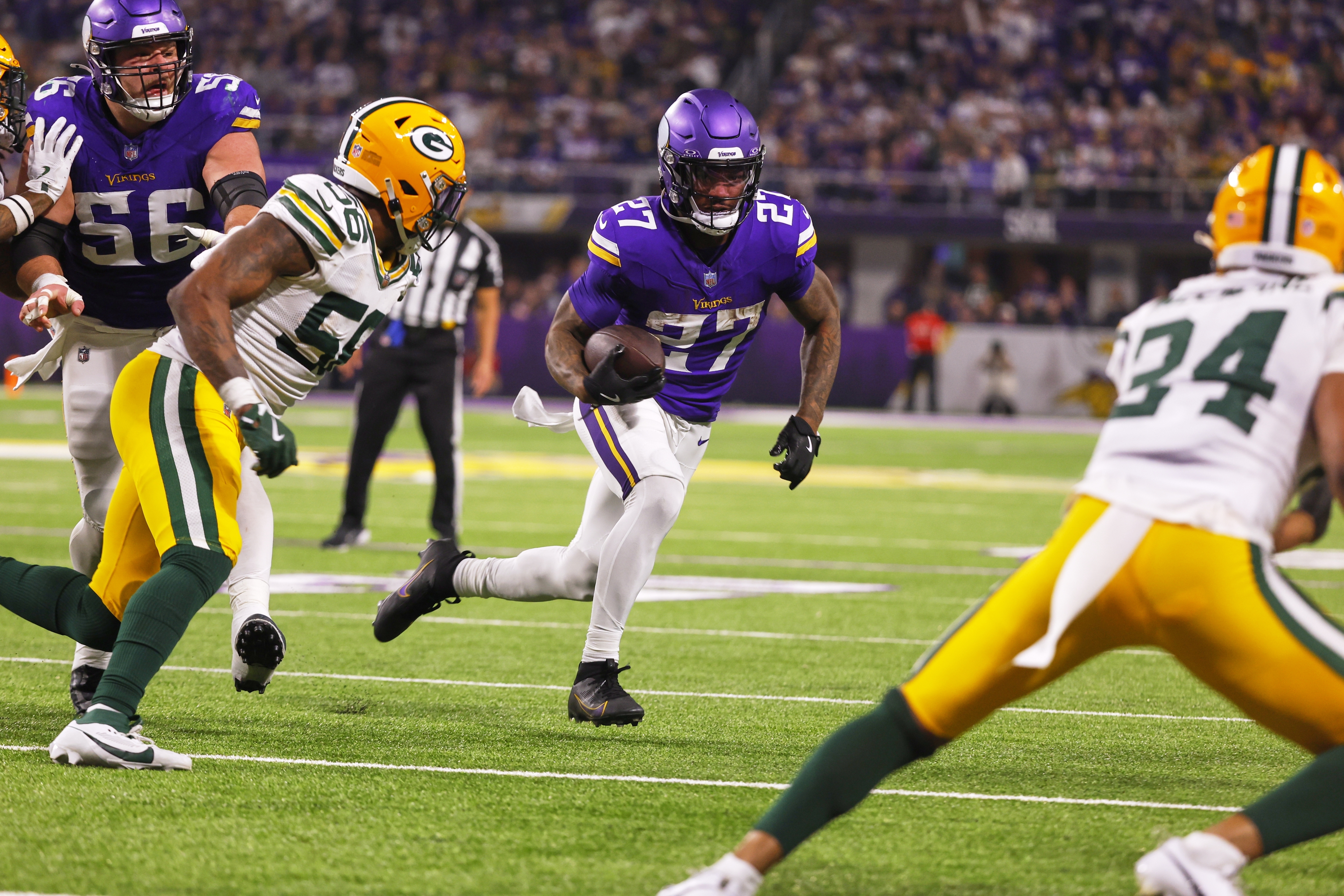 Minnesota Vikings' Cam Akers runs for a touchdown after a catch during the second half of an NFL football game against the Green Bay Packers Sunday, Dec. 29, 2024, in Minneapolis.