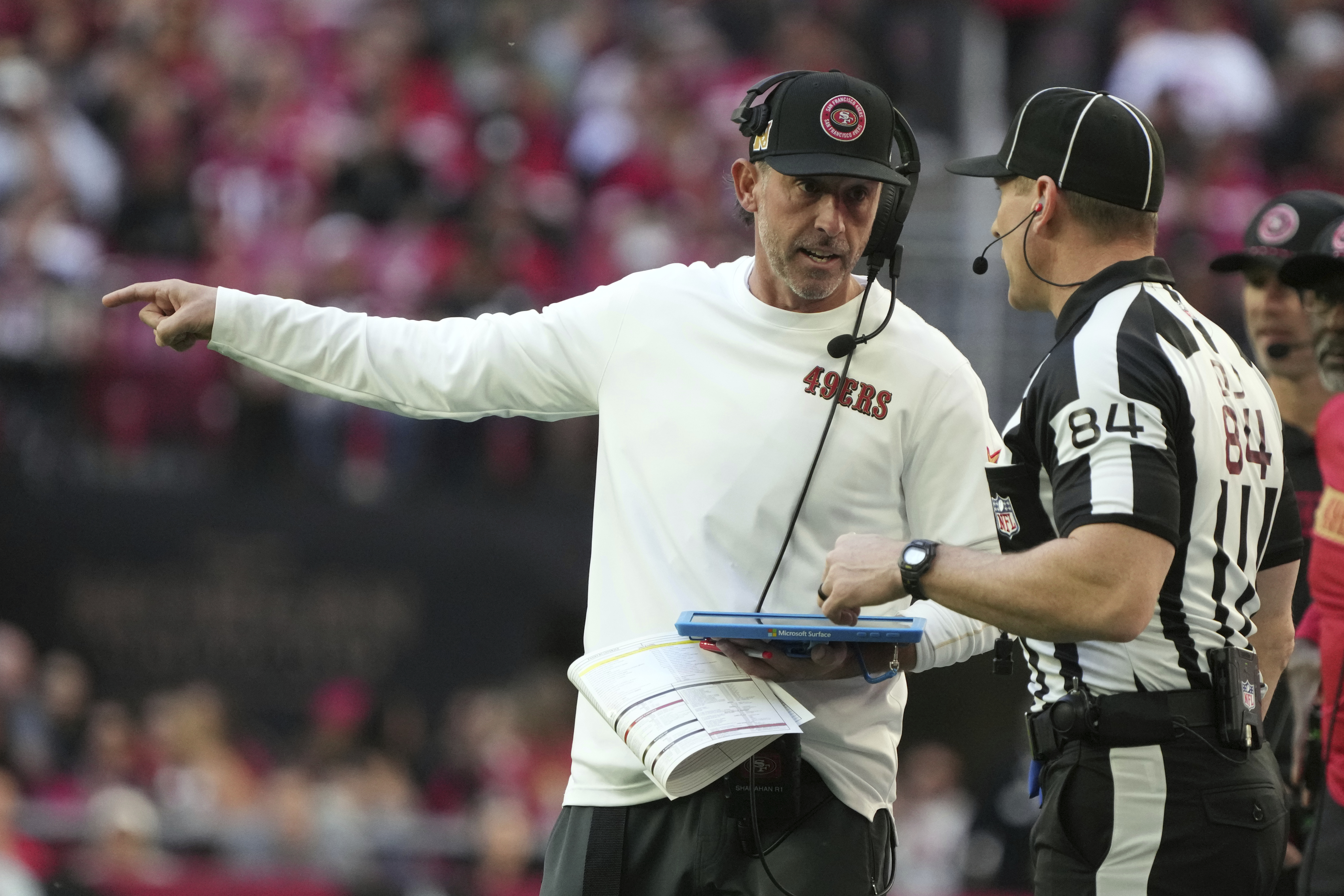 San Francisco 49ers head coach Kyle Shanahan argues a call with an official during the first half of an NFL football game against the Arizona Cardinals in Glendale, Ariz., Sunday, Jan. 5, 2025.