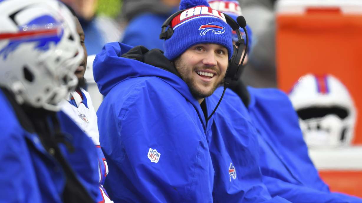 Buffalo Bills quarterback Josh Allen smiles while sitting on the bench during the second half of an NFL football game against the New England Patriots, Sunday, Jan. 5, 2025, in Foxborough, Mass.