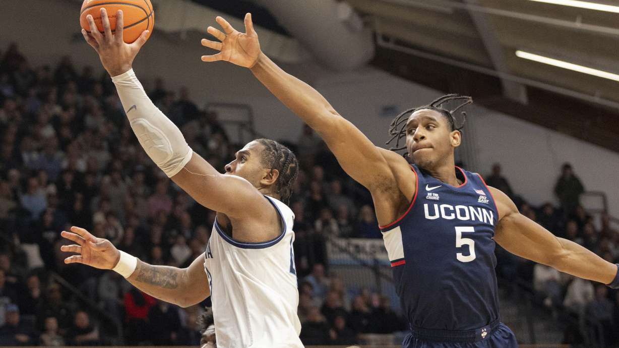 Connecticut center Tarris Reed Jr. (5) follows Villanova forward Eric Dixon (43) to the basket during the second half of an NCAA college basketball game, Wednesday, Jan. 8, 2025, in Villanova, Pa.