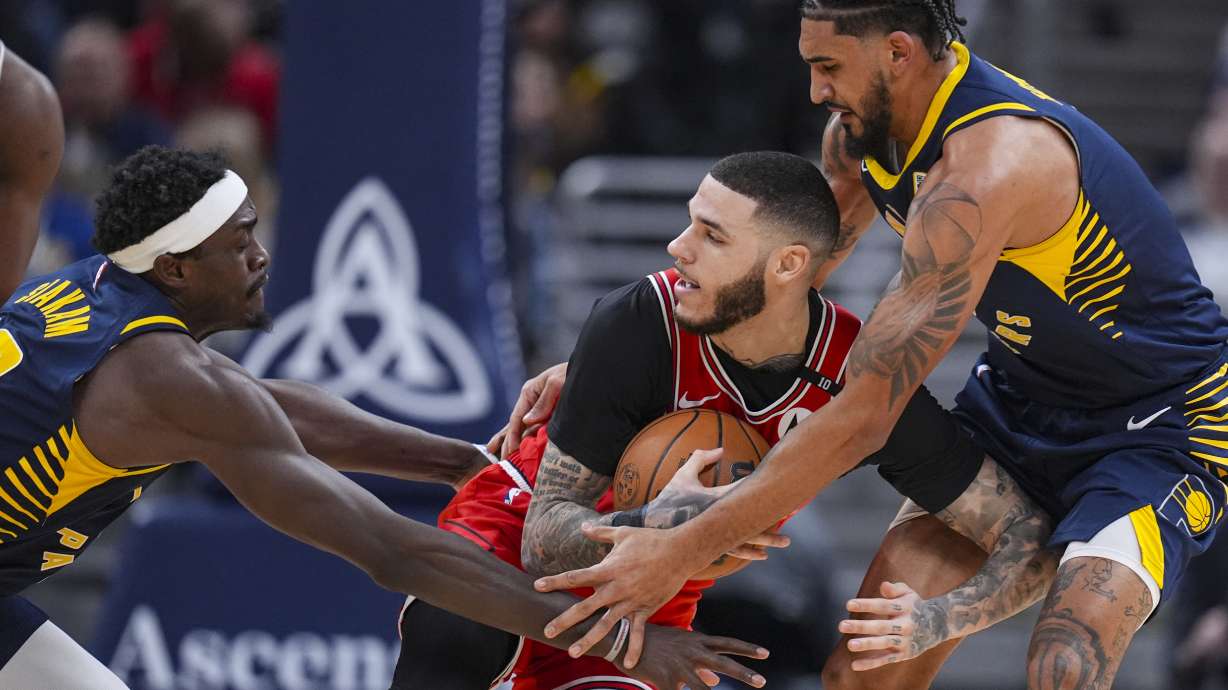 Chicago Bulls guard Lonzo Ball (2) is trapped by Indiana Pacers forward Pascal Siakam (43) and forward Obi Toppin (1) during the first half of an NBA basketball game in Indianapolis, Wednesday, Jan. 8, 2025.