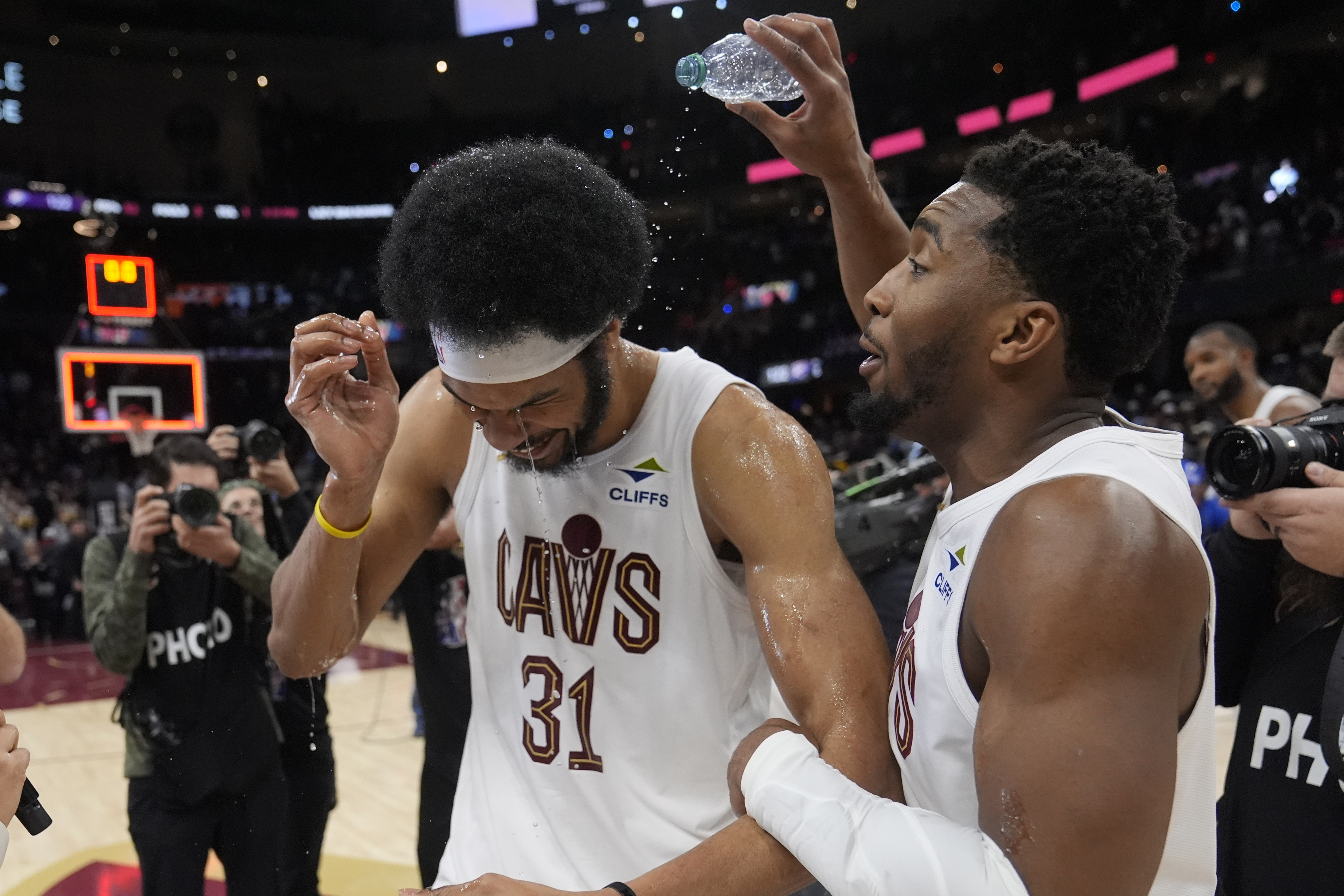 Cleveland Cavaliers guard Donovan Mitchell, right, celebrates with Jarrett Allen (31) after the Cavaliers defeated the Oklahoma City Thunder in an NBA basketball game, Wednesday, Jan. 8, 2025, in Cleveland.