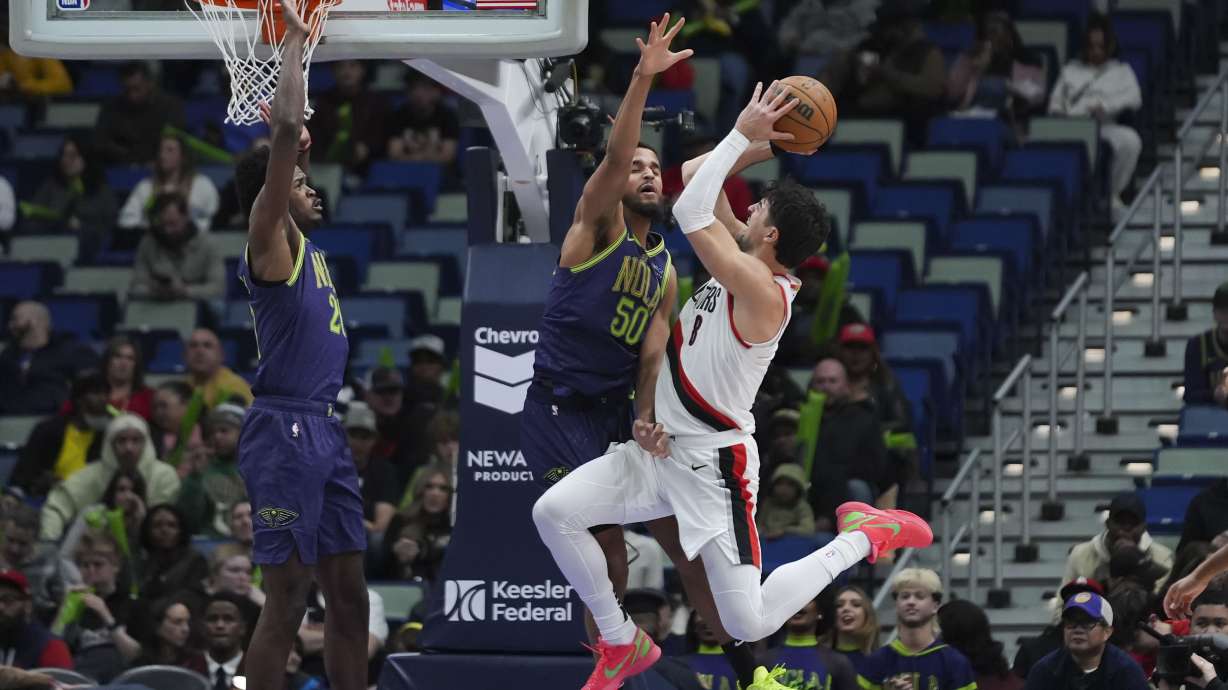 Portland Trail Blazers forward Deni Avdija (8) is fouled by New Orleans Pelicans forward Jeremiah Robinson-Earl (50) as he drives to the basket in the second half of an NBA basketball game in New Orleans, Wednesday, Jan. 8, 2025.