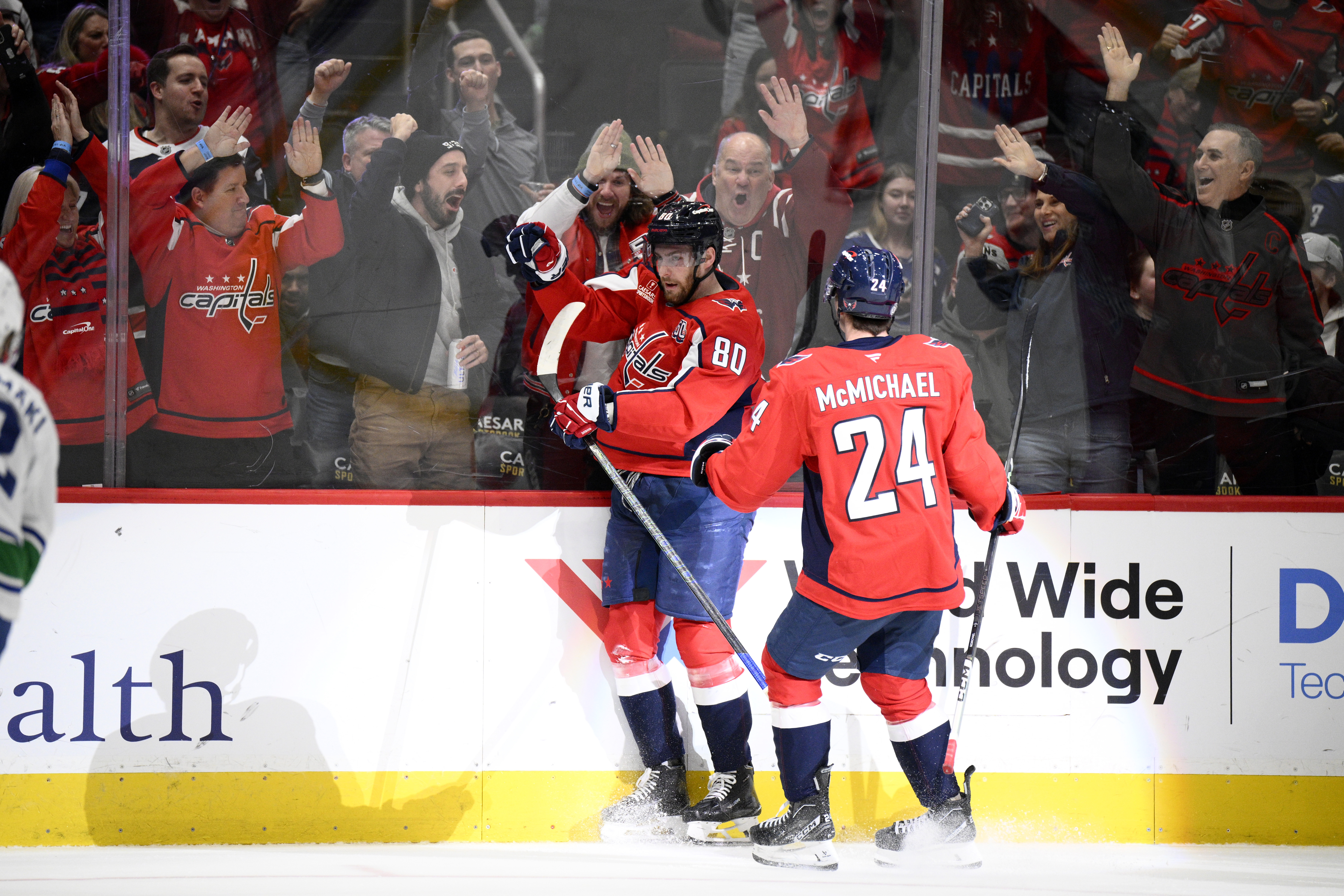 Washington Capitals left wing Pierre-Luc Dubois (80) celebrates his goal with center Connor McMichael (24) during the first period of an NHL hockey game against the Vancouver Canucks, Wednesday, Jan. 8, 2025, in Washington.