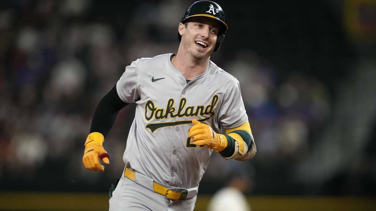 FILE - Oakland Athletics designated hitter Brent Rooker rounds the bases after hitting a home run during a baseball game against the Texas Rangers, Aug. 30, 2024, in Arlington, Texas.