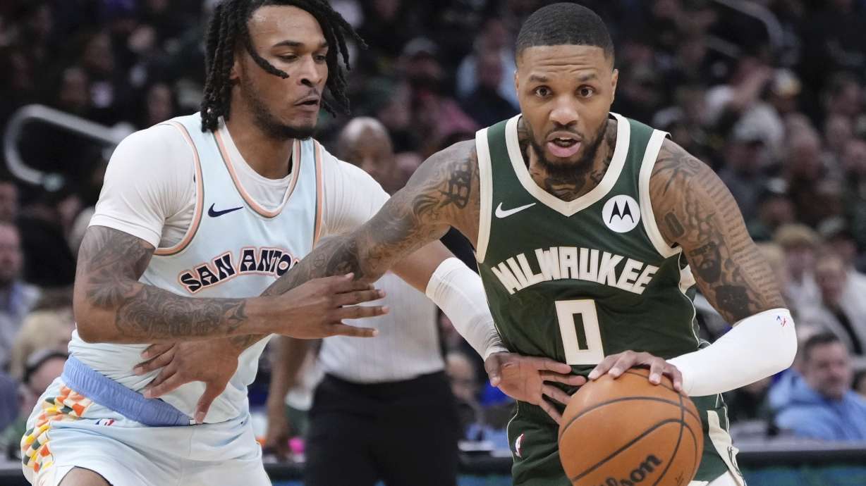 Milwaukee Bucks' Damian Lillard gets past San Antonio Spurs' Stephon Castle during the first half of an NBA basketball game Wednesday, Jan. 8, 2025, in Milwaukee.