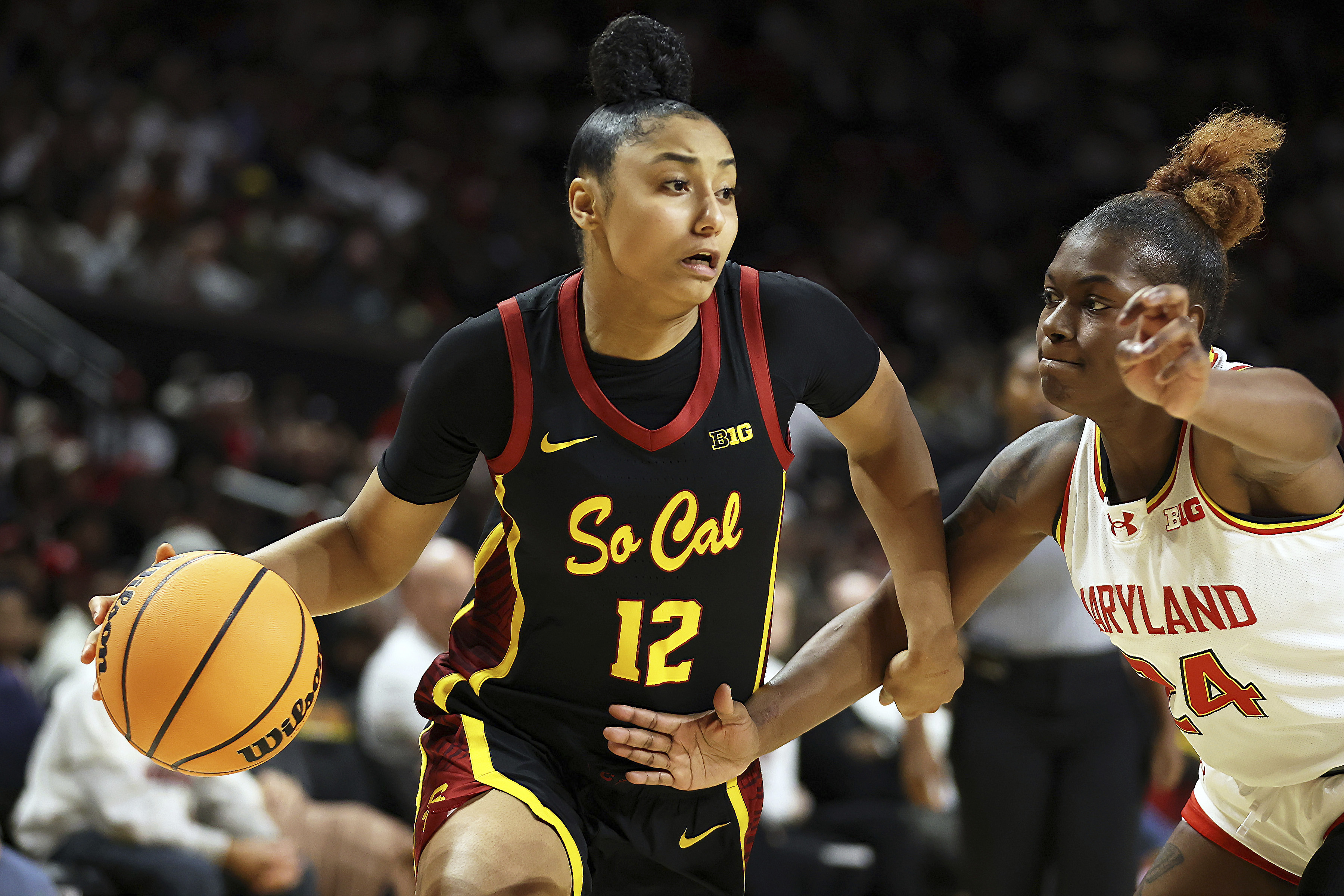 Southern California guard JuJu Watkins (12) drives past Maryland guard Bri McDaniel (24) during the second half of an NCAA college basketball game, Wednesday, Jan. 8, 2025, in College Park, Md.