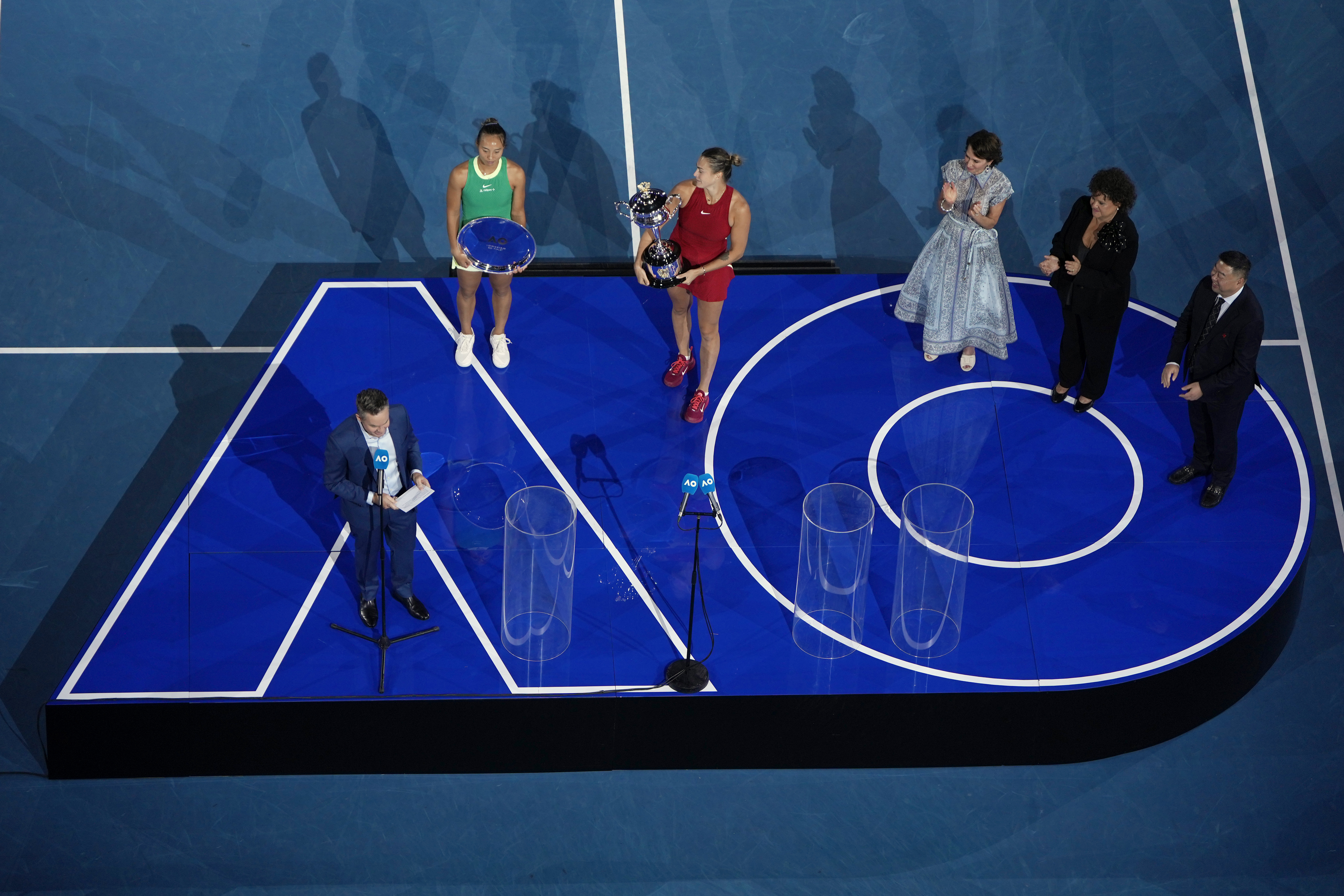 FILE - Aryna Sabalenka of Belarus, center, holds the Daphne Akhurst Memorial Cup after defeating Zheng Qinwen of China, second left, in the women's singles final at the Australian Open tennis championships at Melbourne Park, Melbourne, Australia, Jan. 27, 2024.