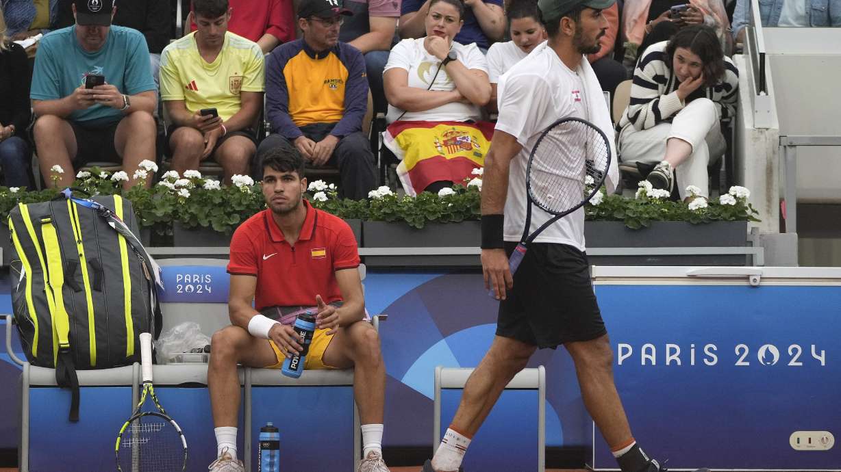 FILE - Hady Habib of Lebanon, right, walks by Carlos Alcaraz of Spain during the men's singles tennis competition, at the 2024 Summer Olympics, Saturday, July 27, 2024, in Paris, France.